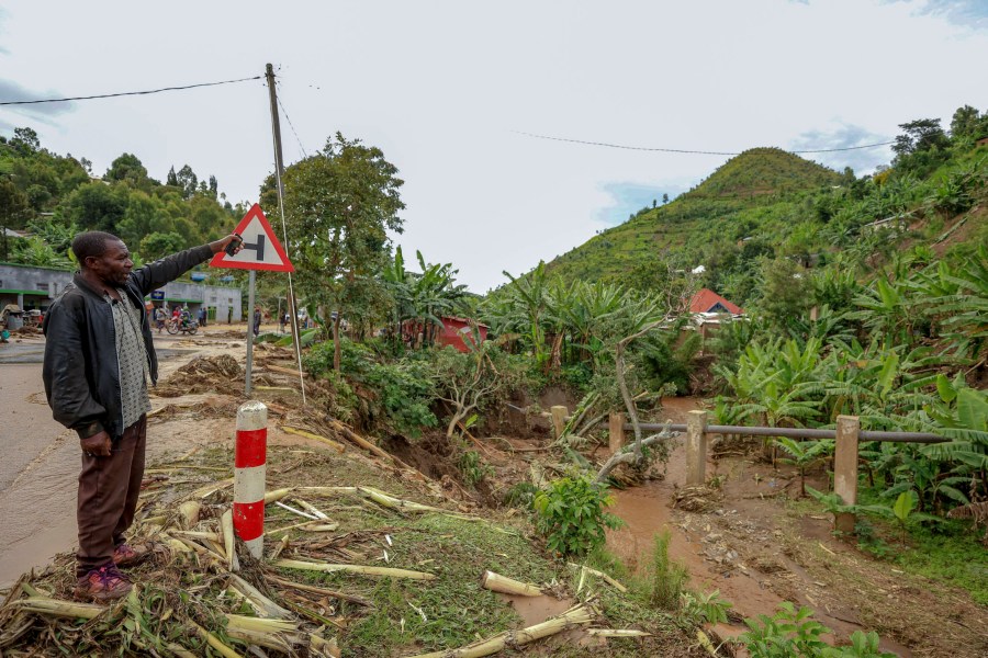 A man stands by floodwater debris in Karongi District, western Rwanda, Wednesday, May 3, 2023. Torrential rains caused flooding in western and northern Rwanda, killing more than 100 people, a public broadcaster said Wednesday. (AP Photo)