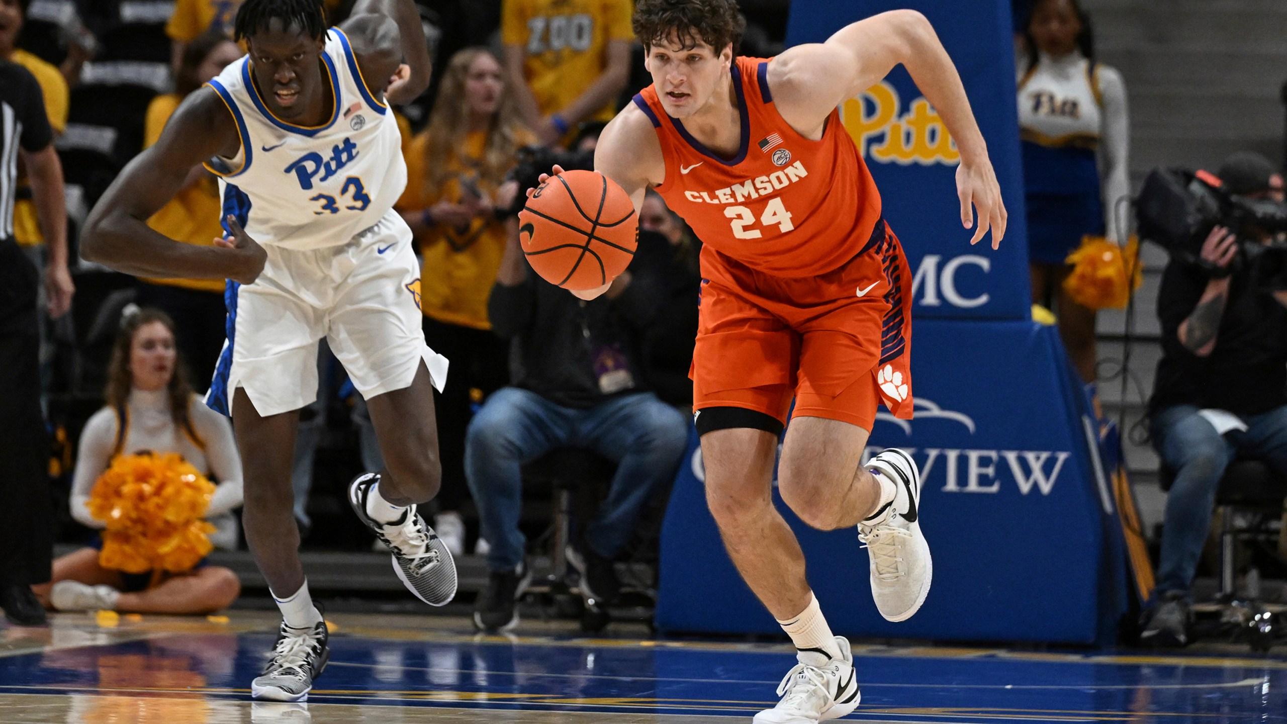 Clemson center PJ Hall (24) drives past Pittsburgh center Federiko Federiko (33) during the first half of an NCAA college basketball game, Sunday, Dec. 3, 2023, in Pittsburgh. (AP Photo/Barry Reeger)
