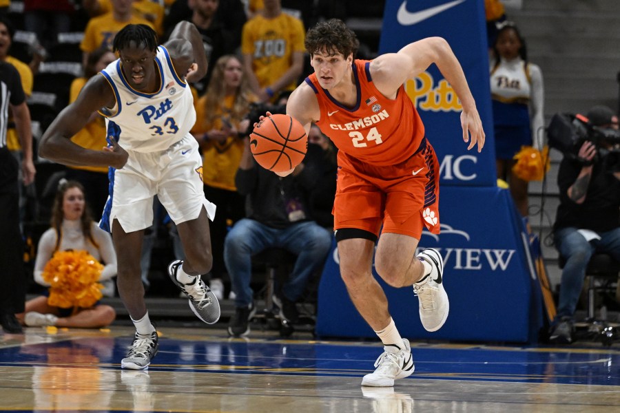 Clemson center PJ Hall (24) drives past Pittsburgh center Federiko Federiko (33) during the first half of an NCAA college basketball game, Sunday, Dec. 3, 2023, in Pittsburgh. (AP Photo/Barry Reeger)