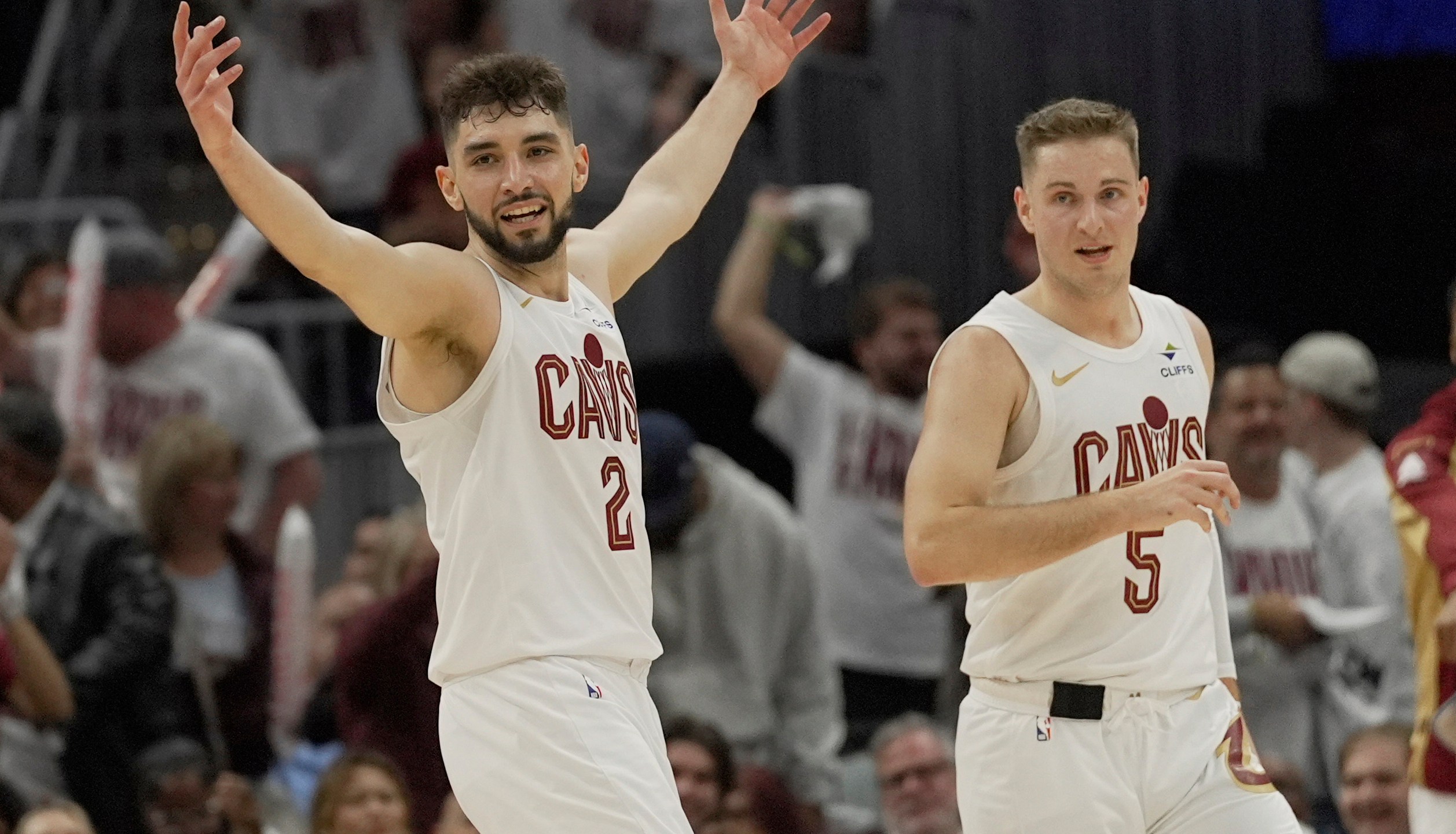 Cleveland Cavaliers guard Ty Jerome (2) celebrates in front of teammate Sam Merrill in the second half in Game 1 of an NBA first-round playoff series against the Miami Heat, Sunday, April 20, 2025, in Cleveland. (AP Photo/Sue Ogrocki)