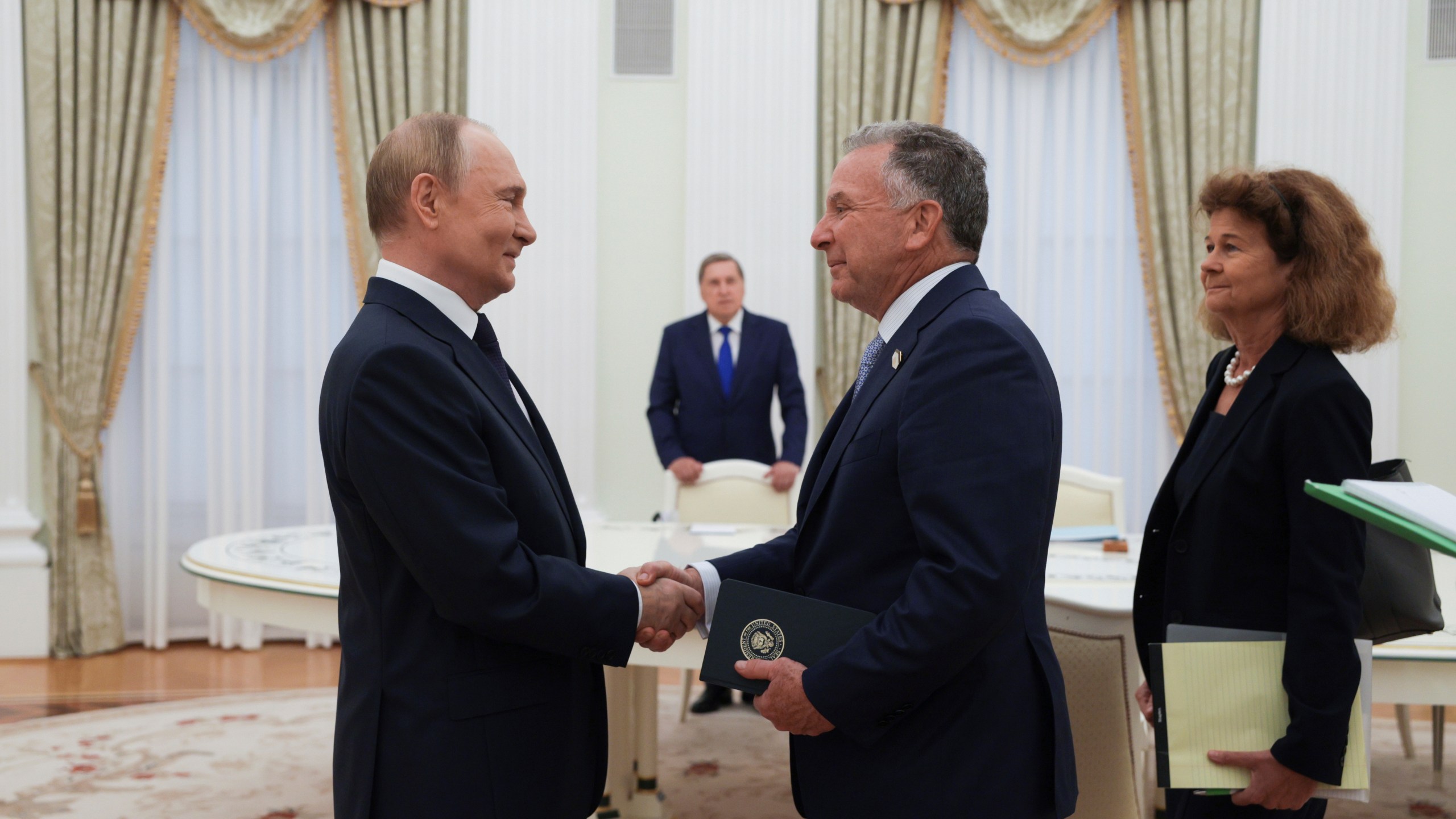 Russian President Vladimir Putin, left, and U.S. President Donald Trump's special envoy Steve Witkoff, right, shake hands during their meeting at the Kremlin in Moscow, Russia, Wednesday, Aug. 6, 2025. (Gavriil Grigorov, Sputnik, Kremlin Pool Photo via AP)