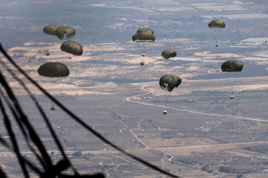 Containers of humanitarian aid are airdropped to Palestinians in the Gaza Strip from a Jordanian Air Force C-130 plane, Thursday, Aug. 7, 2025. (AP Photo/Raad Adayleh)