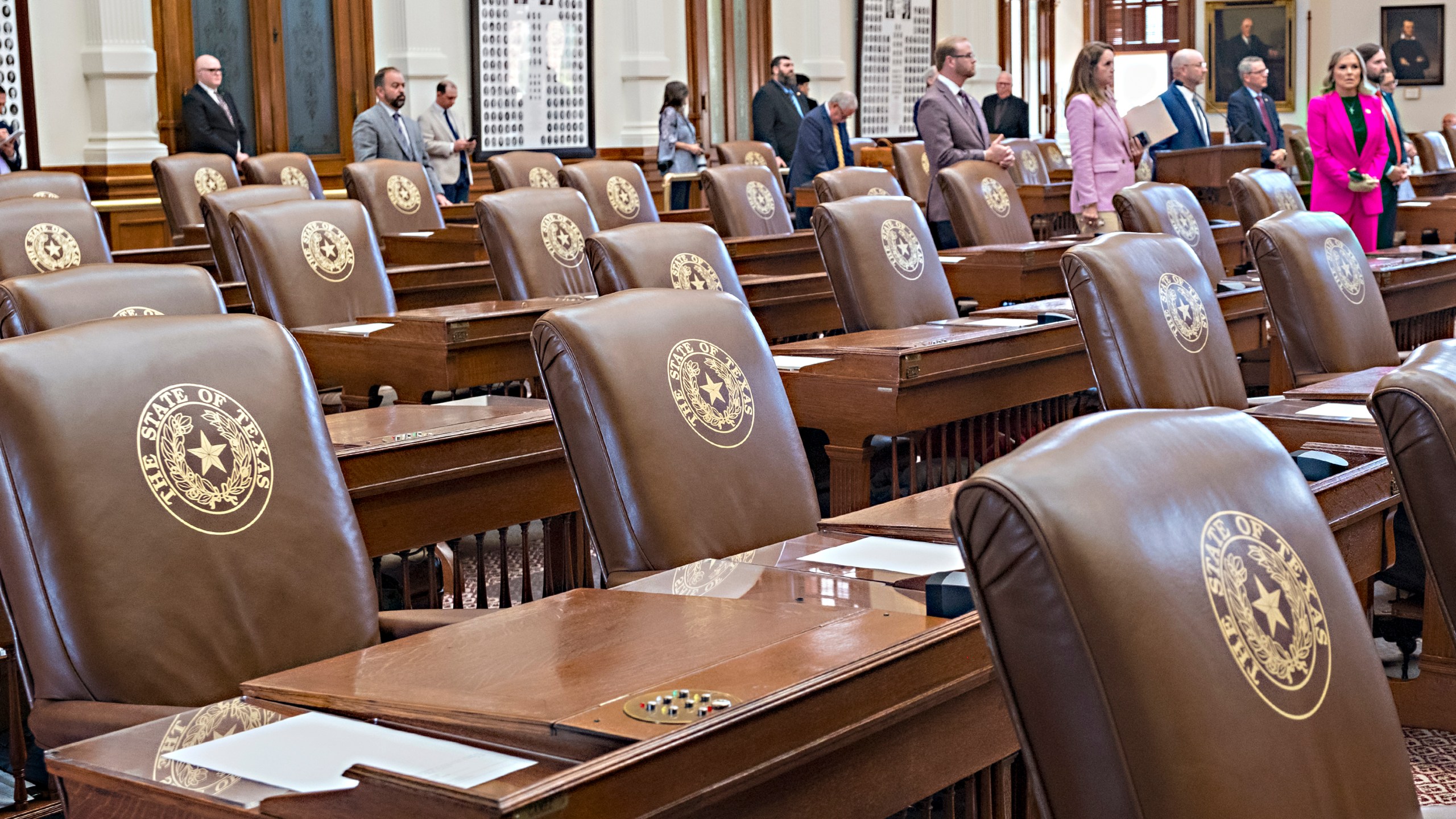 Empty chairs belonging to House Democrats remain empty during a session convocation in the State Capitol, Tuesday, Aug. 5, 2025, in Austin, Texas. (AP Photo/Rodolfo Gonzalez)