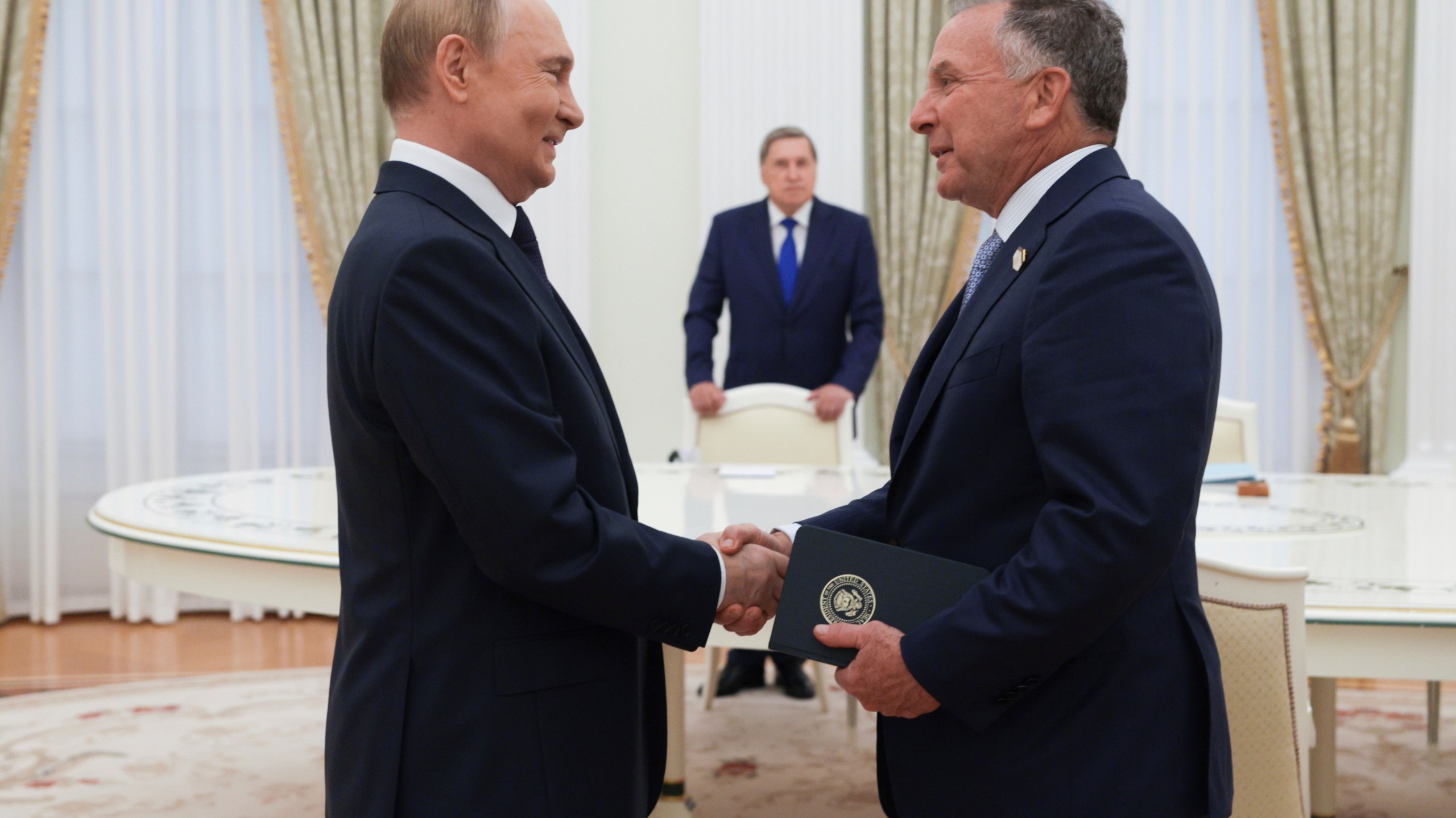 Russian President Vladimir Putin, left, and U.S. President Donald Trump's special envoy Steve Witkoff, right, shake hands during their meeting in Moscow, Russia, Wednesday, Aug. 6, 2025. (Gavriil Grigorov, Sputnik, Kremlin Pool Photo via AP)