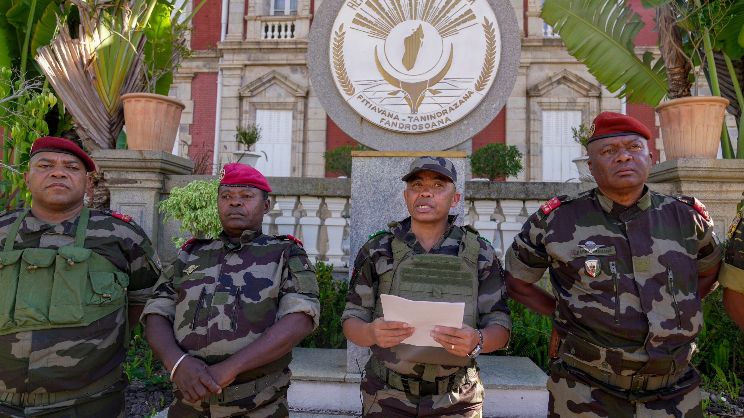 CAPSAT military unit commander Col. Michael Randrianirina, center, reads a statement saying that the armed forces are taking control of the country from the steps of the Presidency in Antananarivo, Madagascar, Tuesday, Oct. 14, 2025. (AP Photo/ Brian Inganga)