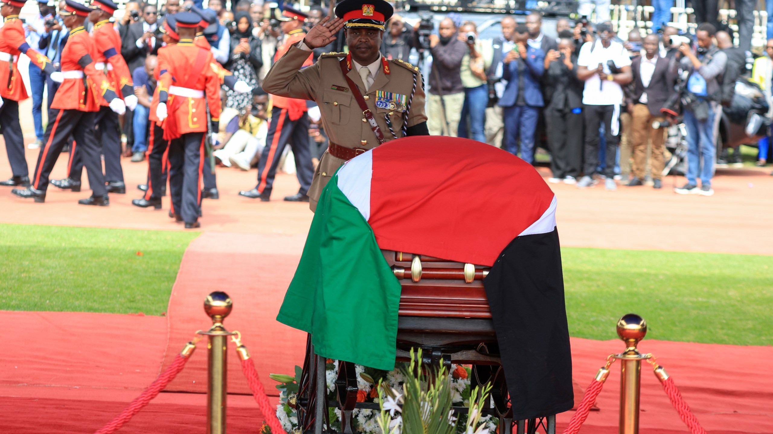 A military officer salutes at a state funeral for former Kenya Prime Minister Raila Odinga at Nyayo National Stadium in Nairobi, Kenya, Friday, Oct. 17, 2025. (AP Photo/Andrew Kasuku)