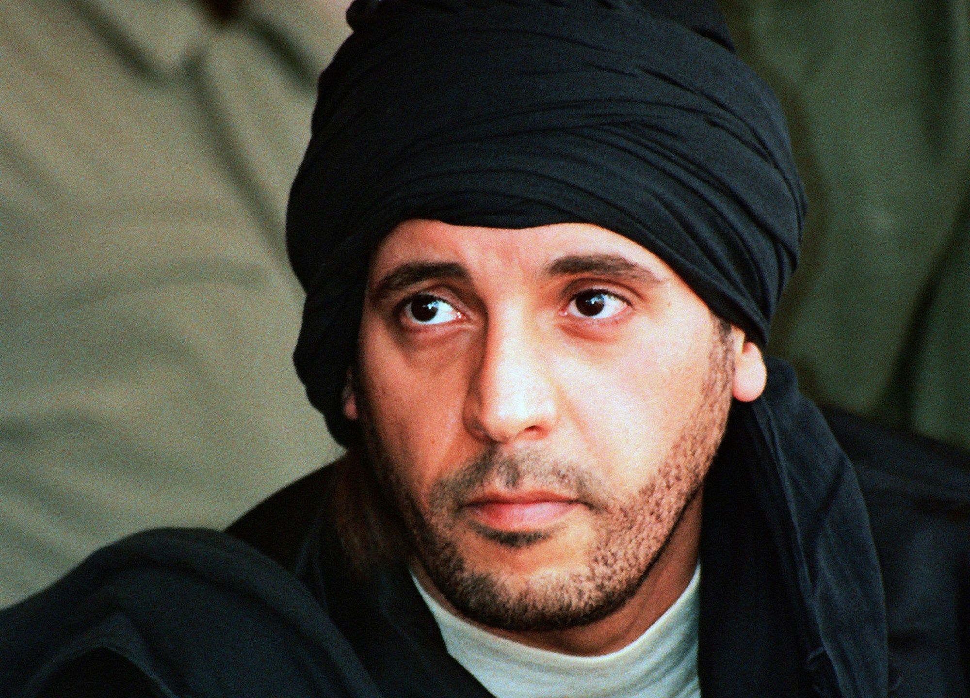 FILE - In this undated file photo made available Sept. 25, 2011, Hannibal Gadhafi, son of ousted Libyan leader Moammar Gadhafi, watches an elite military unit exercise in Zlitan, Libya. (AP Photo/Abdel Magid al-Fergany, File)