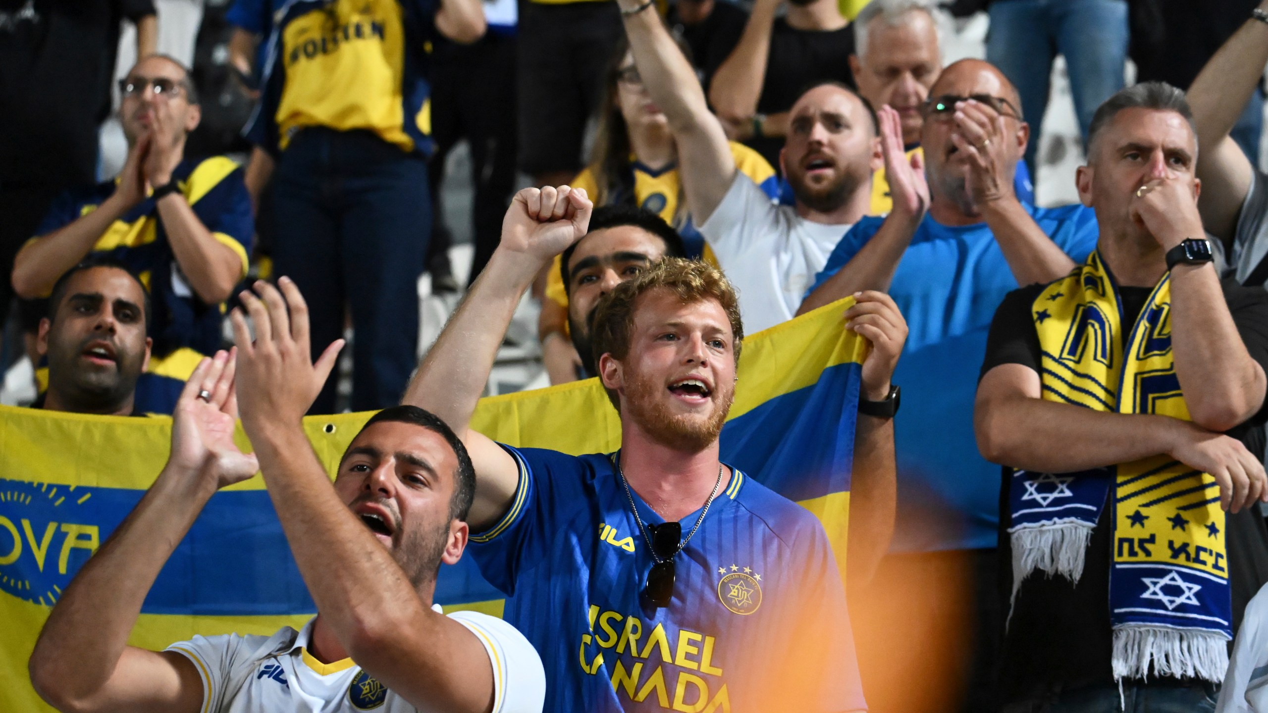 FILE -Maccabi Tel Aviv's fans clap hands after the end of the Europa League soccer match between PAOK and Maccabi Tel Aviv at Toumpa stadium, in Thessaloniki, Greece, Sept. 24, 2025. (AP Photo/Giannis Papanikos, File)