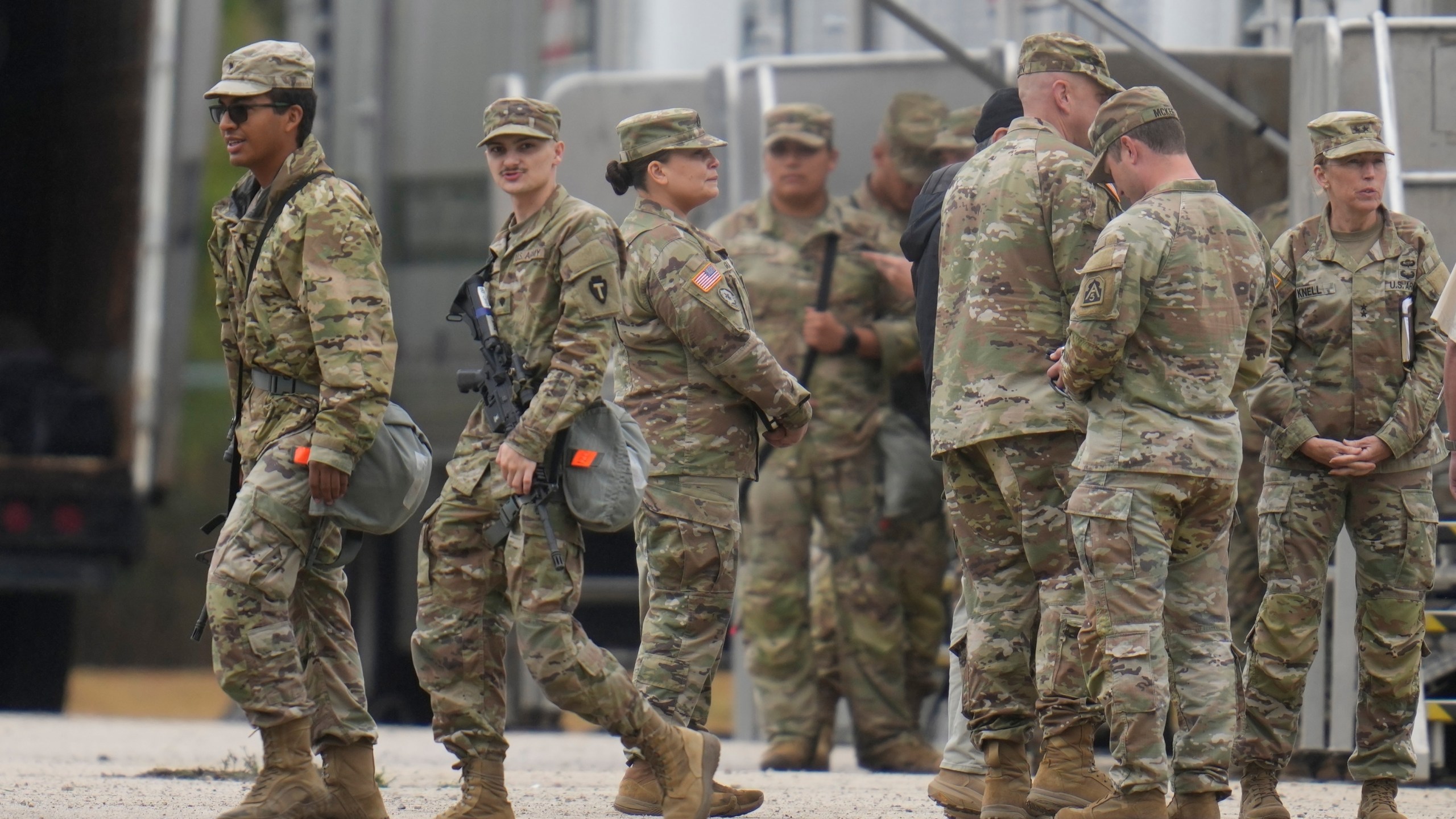 Military personnel in uniform, with the Texas National Guard patch on, are seen at the U.S. Army Reserve Center, Tuesday, Oct. 7, 2025, in Elwood, Ill., a suburb of Chicago. (AP Photo/Erin Hooley)