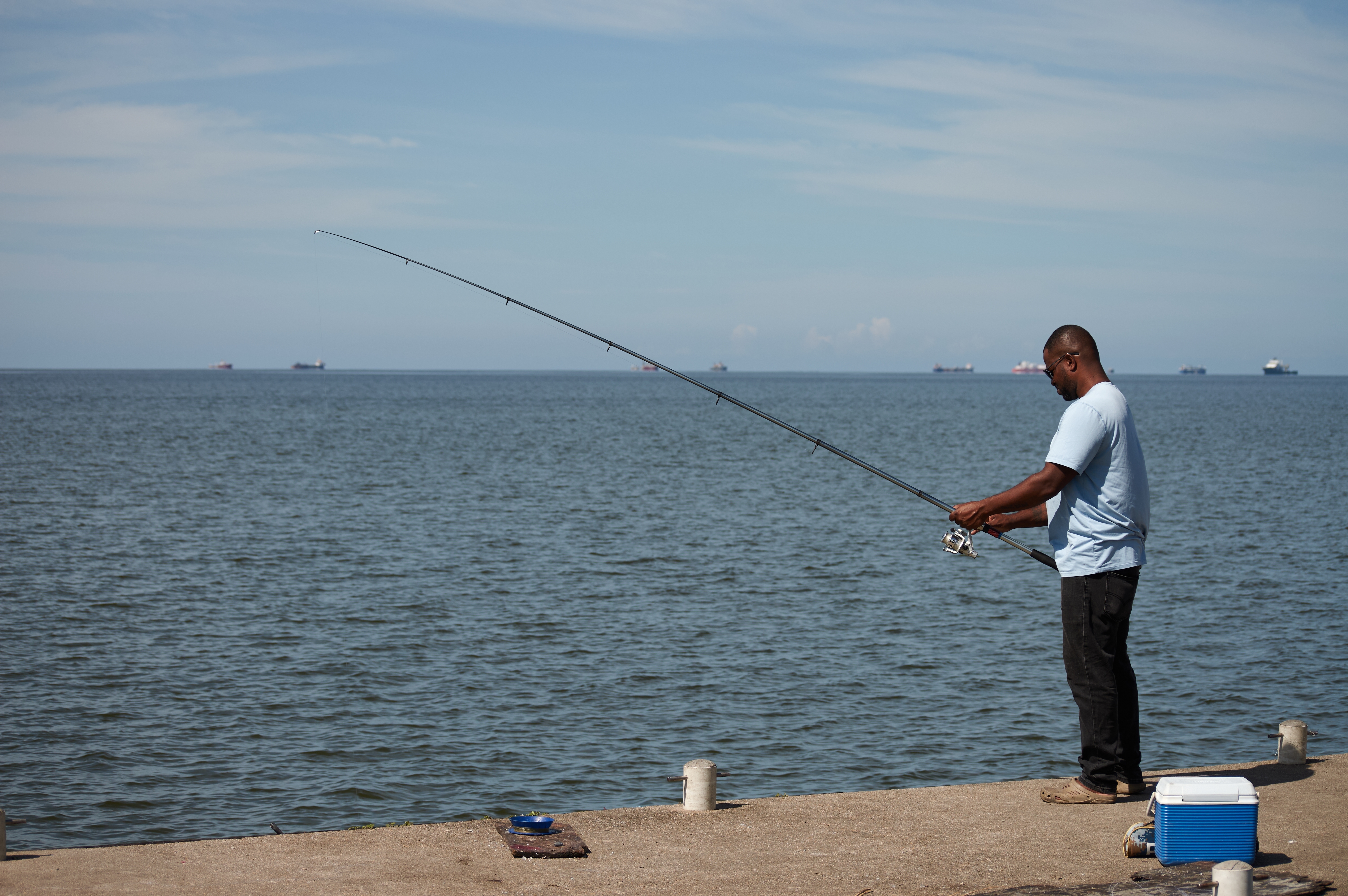 A man fishes in Cocorite, Trinidad and Tobago, Friday, Oct. 3, 2025. (AP Photo/Anselm Gibbs)