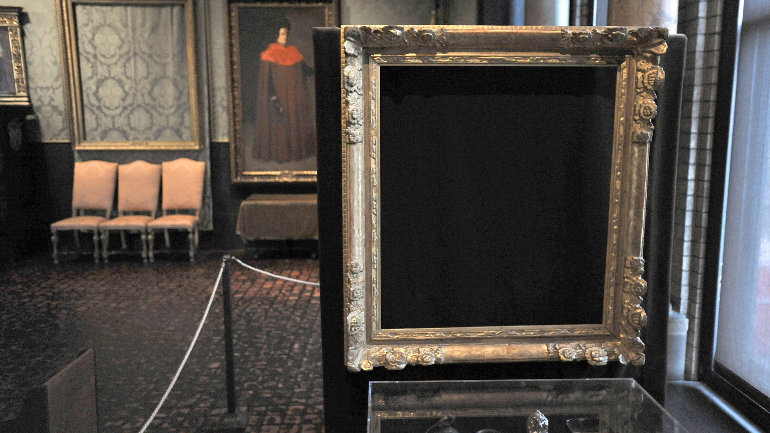 FILE - In this March 11, 2010 file photo, empty frames from which thieves took "Storm on the Sea of Galilee," left background, by Rembrandt and "The Concert," right foreground, by Vermeer, remain on display at the Isabella Stewart Gardner Museum in Boston. (AP Photo/Josh Reynolds, File)