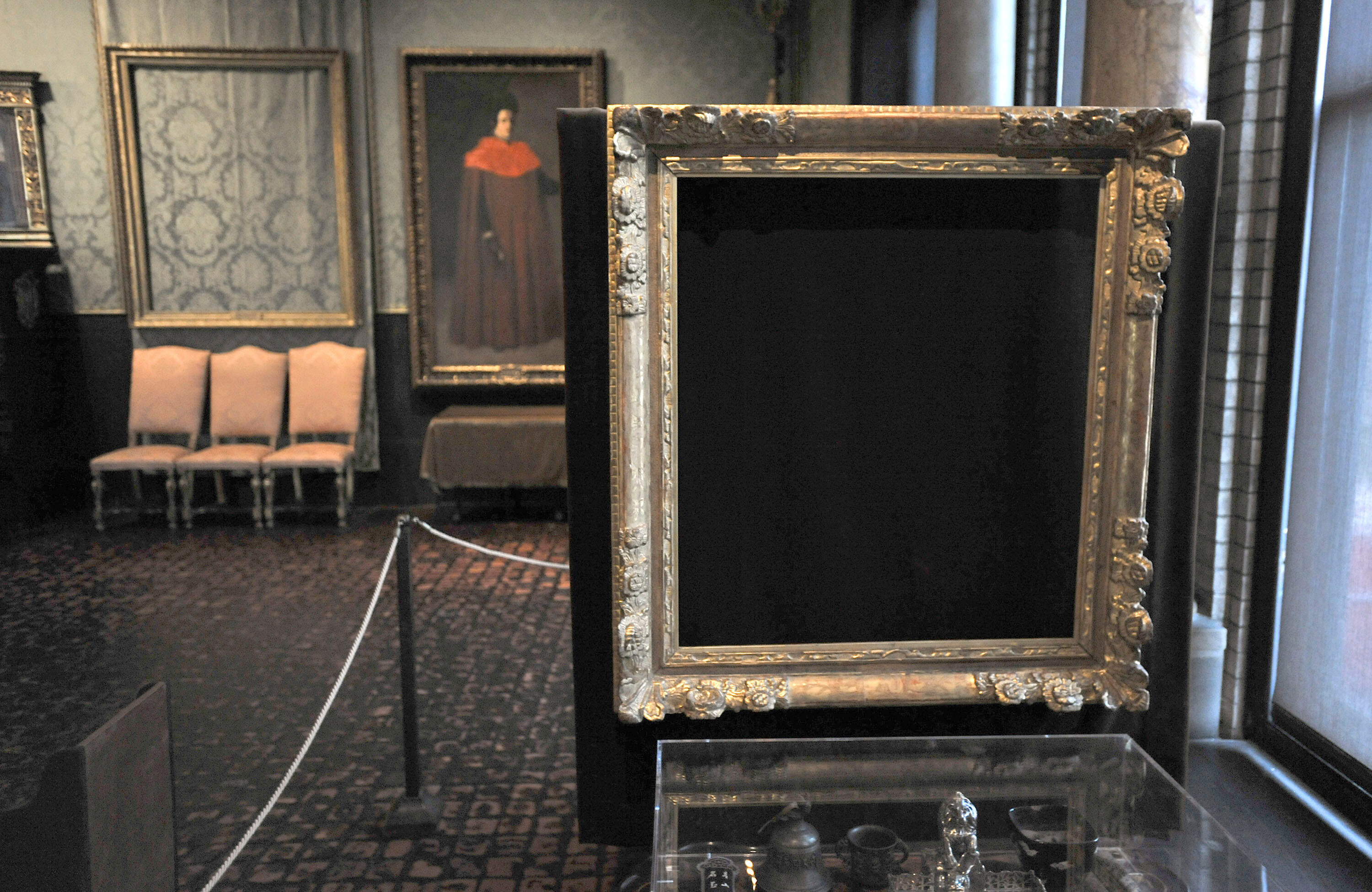 FILE - In this March 11, 2010 file photo, empty frames from which thieves took "Storm on the Sea of Galilee," left background, by Rembrandt and "The Concert," right foreground, by Vermeer, remain on display at the Isabella Stewart Gardner Museum in Boston. (AP Photo/Josh Reynolds, File)