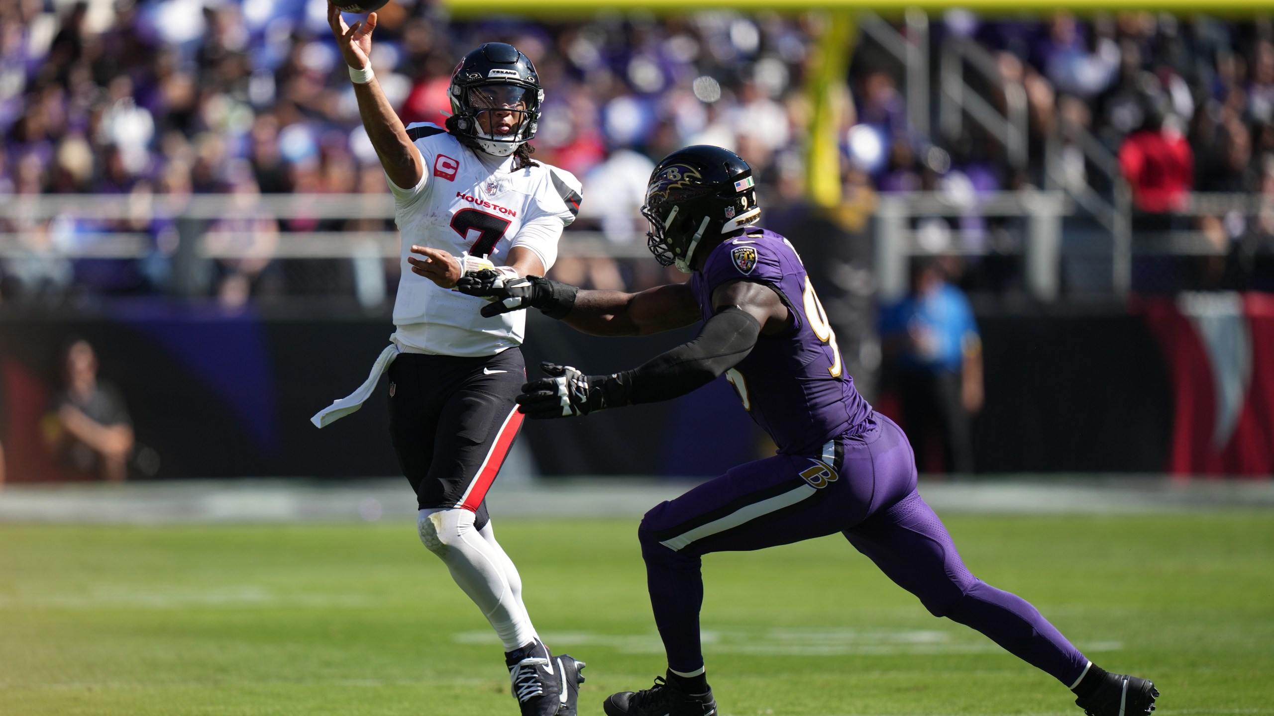 Houston Texans quarterback C.J. Stroud (7) throws against Baltimore Ravens linebacker Odafe Oweh (99) during the first half of an NFL football game, Sunday, Oct. 5, 2025, in Baltimore. (AP Photo/Stephanie Scarbrough)
