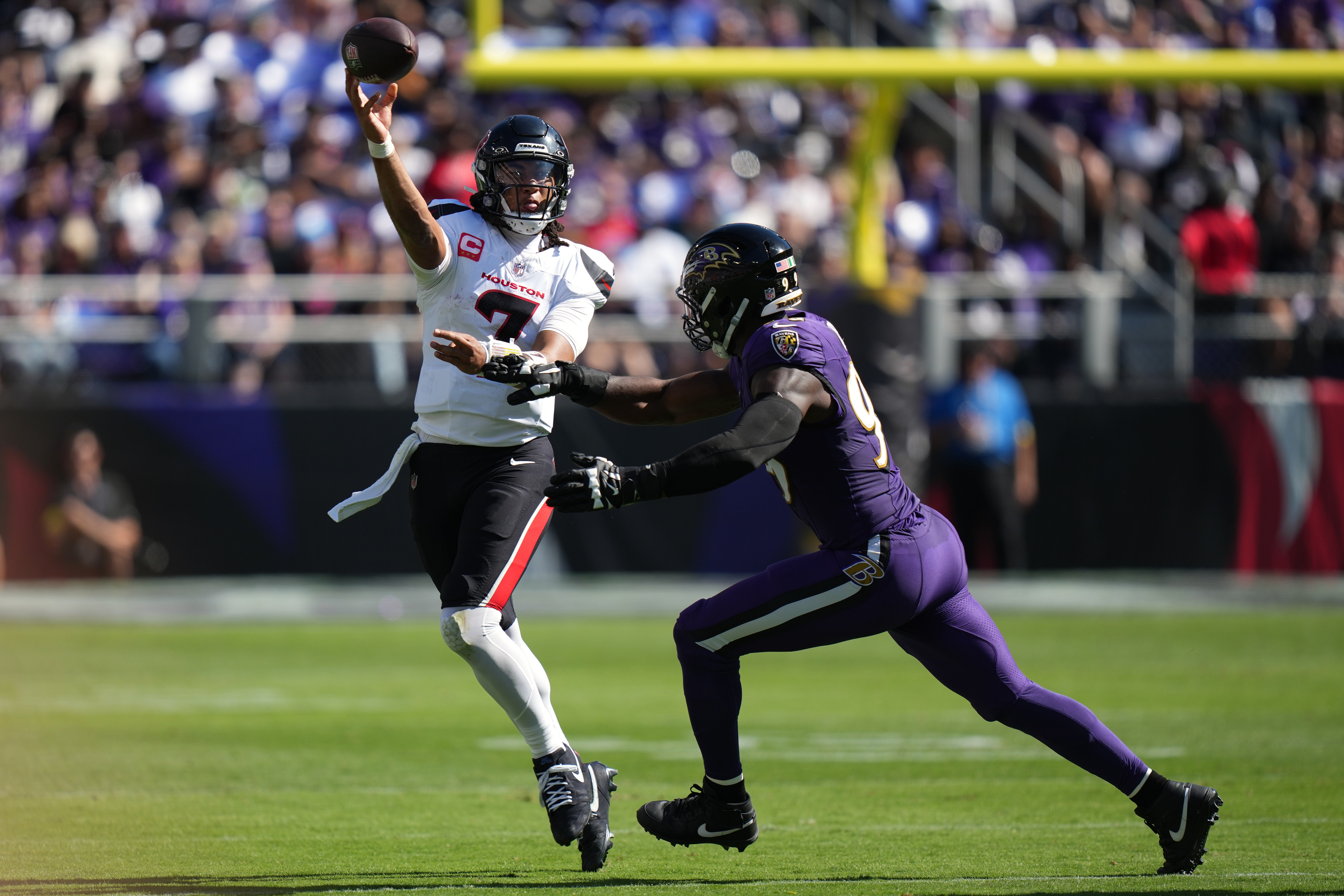 Houston Texans quarterback C.J. Stroud (7) throws against Baltimore Ravens linebacker Odafe Oweh (99) during the first half of an NFL football game, Sunday, Oct. 5, 2025, in Baltimore. (AP Photo/Stephanie Scarbrough)