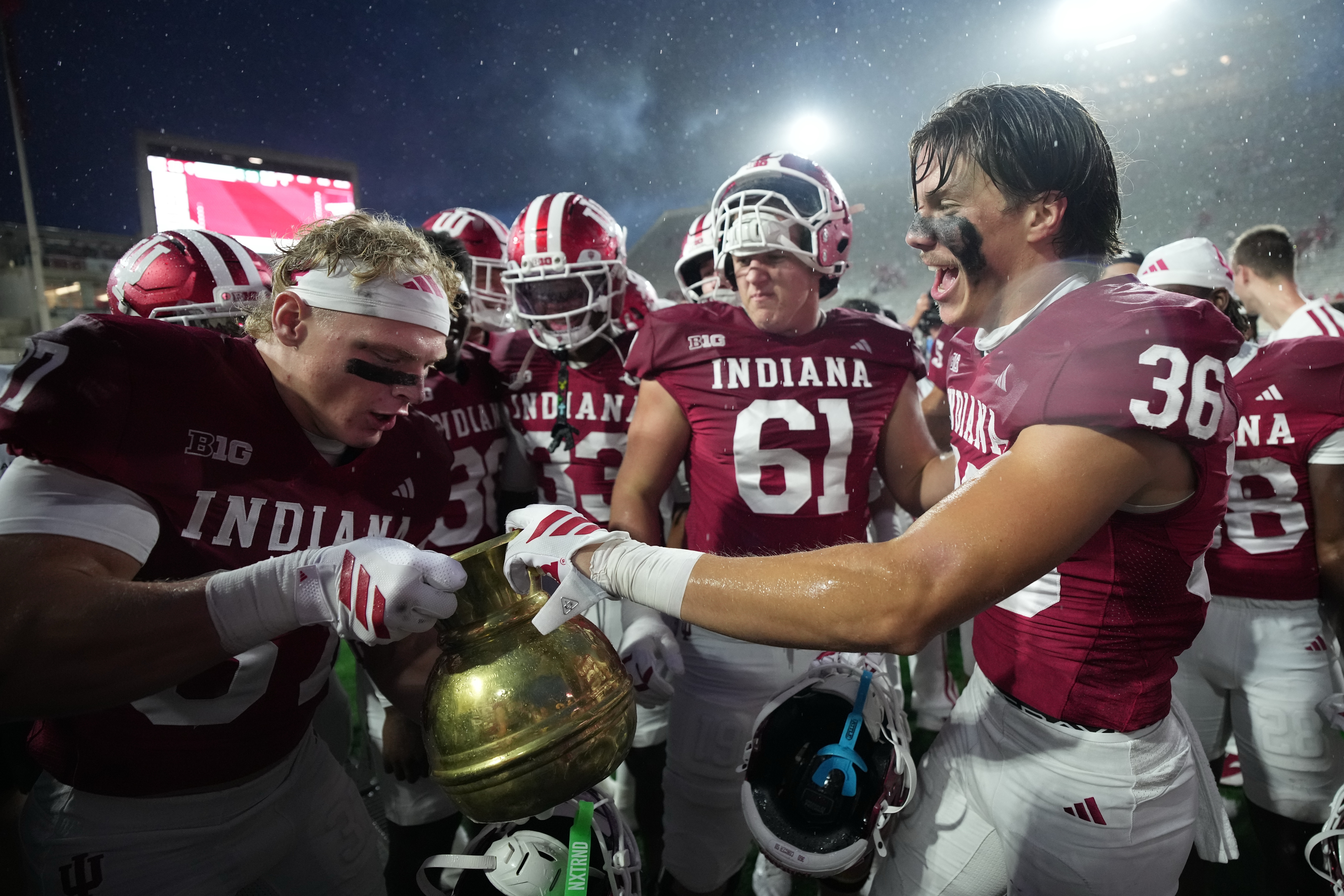 Indiana players celebrate with the Old Brass Spittoon following an NCAA college football game against the Michigan State, Saturday, Oct. 18, 2025, in Bloomington, Ind. (AP Photo/AJ Mast)