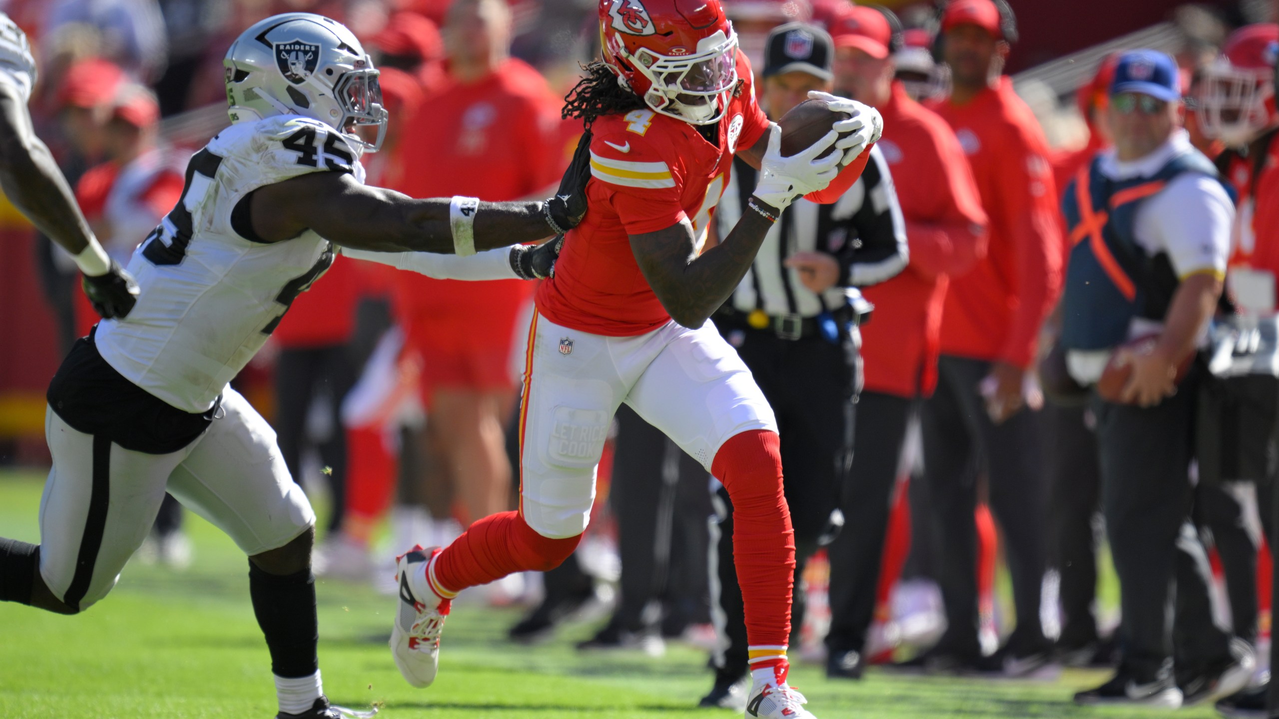 Kansas City Chiefs wide receiver Rashee Rice (4) is pushed out of bounds by Las Vegas Raiders linebacker Devin White (45) during the first half of an NFL football game Sunday, Oct. 19, 2025, in Kansas City, Mo. (AP Photo/Reed Hoffmann)