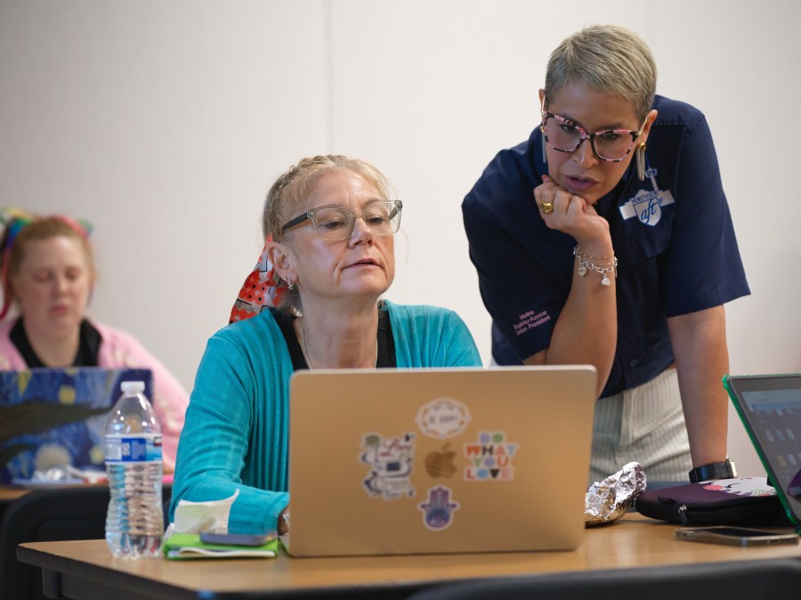 Northside American Federation of Teachers President Melina Espiritu-Azocar, right, speaks with middle school teacher Celeste Simone during a Microsoft AI skilling event, Saturday, Sept. 27, 2025, in San Antonio. (AP Photo/Darren Abate)