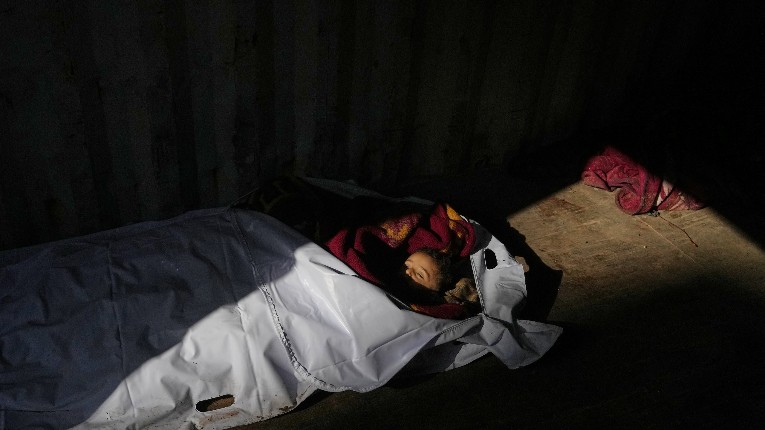 The body of 4-year-old Palestinian, Ahmed Weshah lies next to that of his mother Afaf Abu Jahjouh, 28, who were both killed in an Israeli military strike on Sunday, before their funeral at Awda Hospital, in Nuseirat, in the central Gaza Strip, Monday, Oct. 20, 2025. (AP Photo/Abdel Kareem Hana)