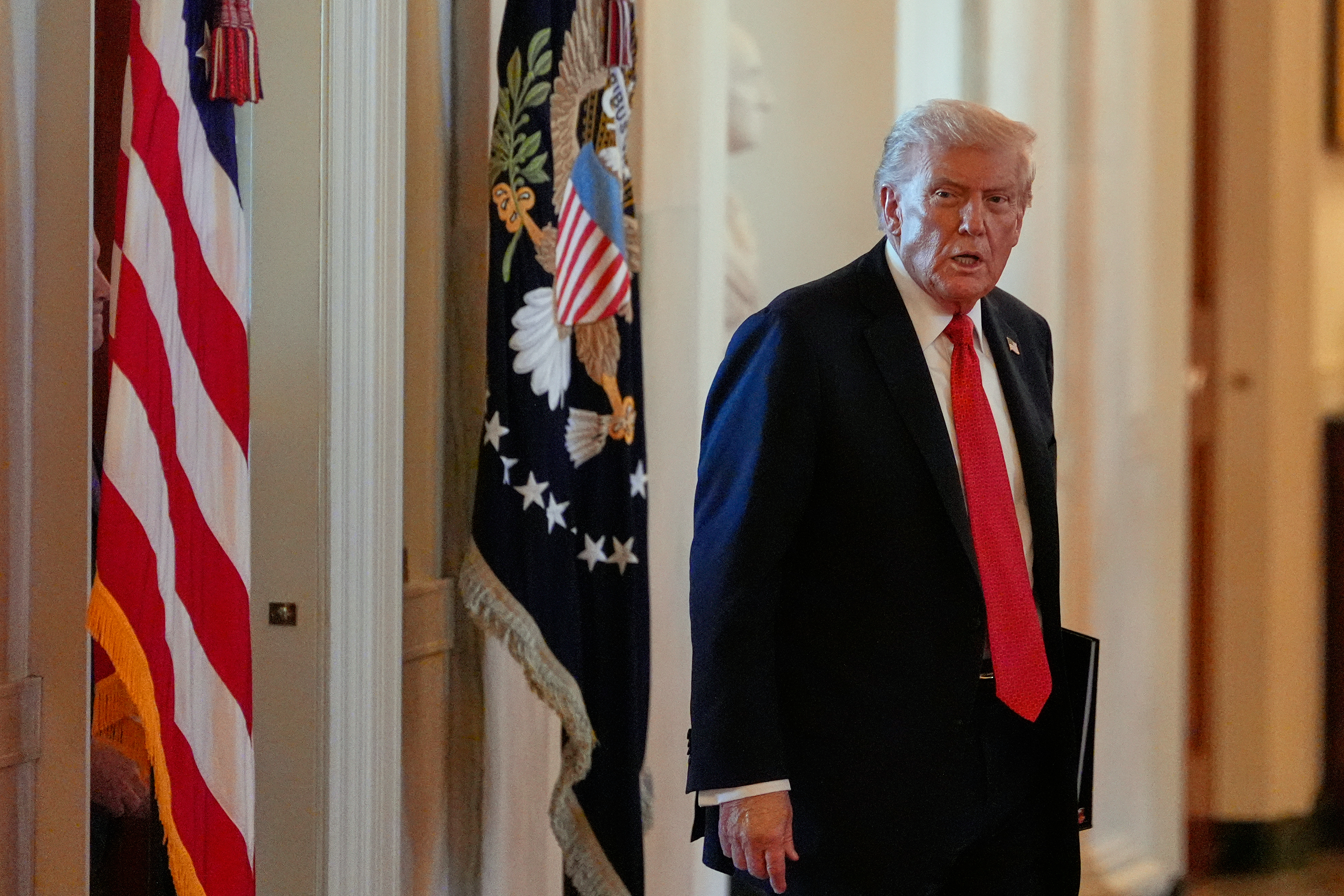 President Donald Trump arrives to speak during an event to welcome the 2025 LSU and LSU-Shreveport national champion baseball teams in the East Room of the White House, Monday, Oct. 20, 2025, in Washington. (AP Photo/Alex Brandon)