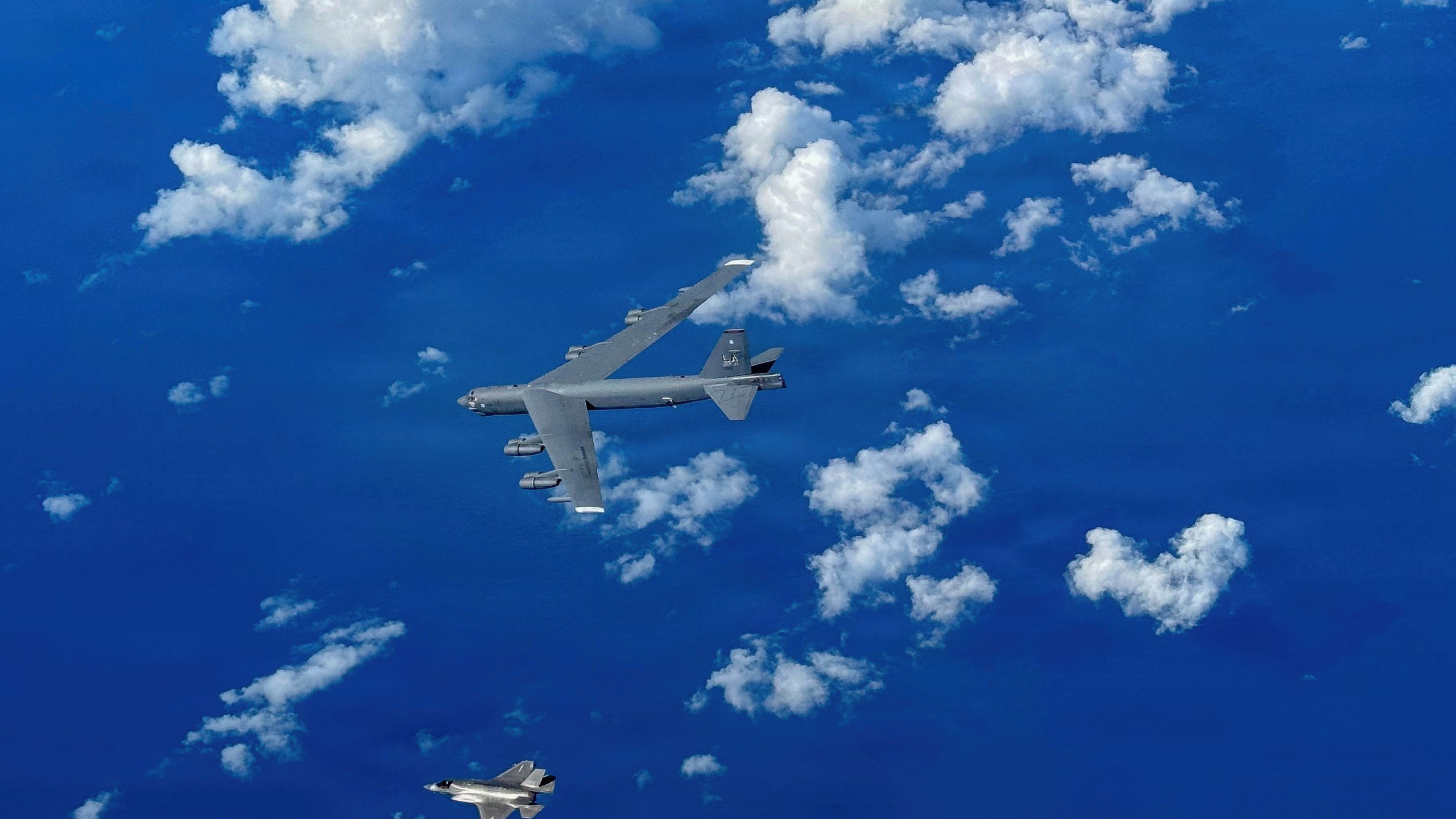 In this image provided by the U.S. Air Force, A Marine Corps F-35B Lightning II aircraft flies alongside a U.S. Air Force B-52H Stratofortress bomber in the U.S. Southern Command area of responsibility, Oct. 15, 2025. (U.S. Air Force via AP)