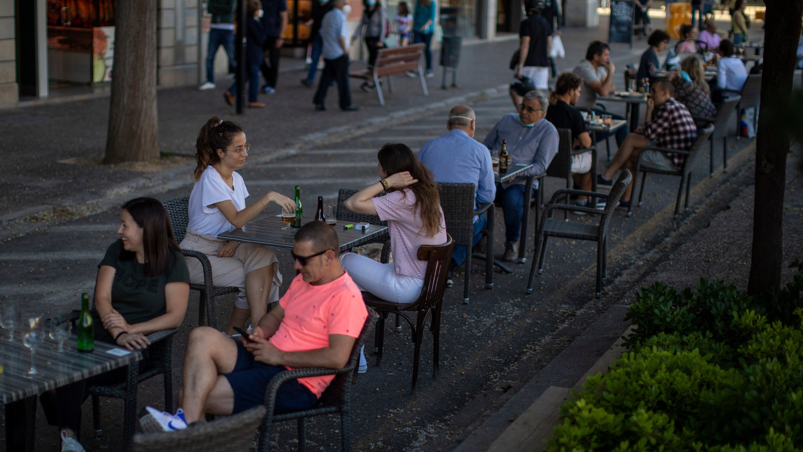 FILE - Customers sit at a terrace bar in Girona, Spain, on May 18, 2020. (AP Photo/Emilio Morenatti, File)