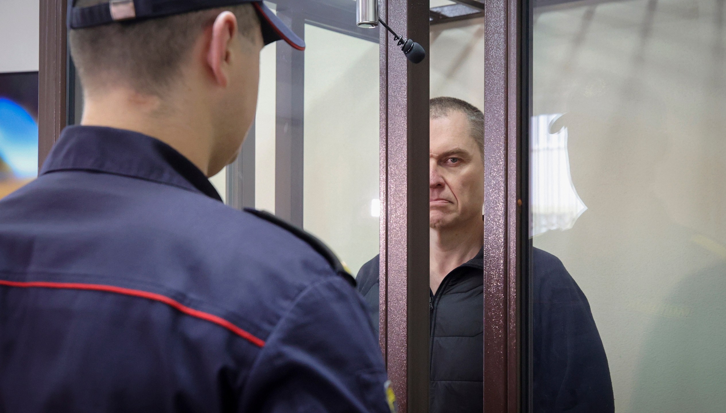 FILE -Journalist Andrzej Poczobut stands in a defendants' cage during a court session in Grodno, Belarus, Jan. 16, 2023. (Leonid Shcheglov/Pool via AP, File)