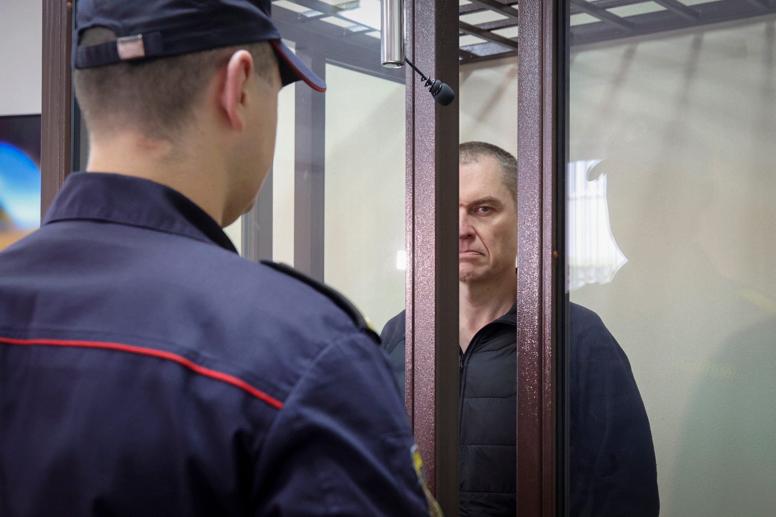 FILE -Journalist Andrzej Poczobut stands in a defendants' cage during a court session in Grodno, Belarus, Jan. 16, 2023. (Leonid Shcheglov/Pool via AP, File)