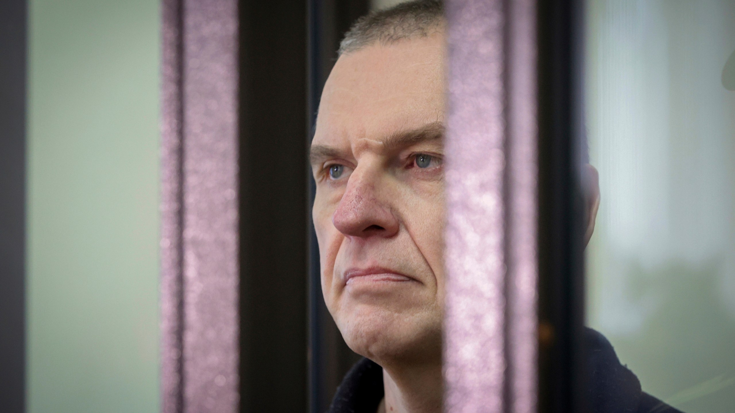 FILE - Journalist Andrzej Poczobut stands in a defendants' cage in court in Grodno, Belarus, on Jan. 16, 2023. (Leonid Shcheglov/Pool via AP, File)