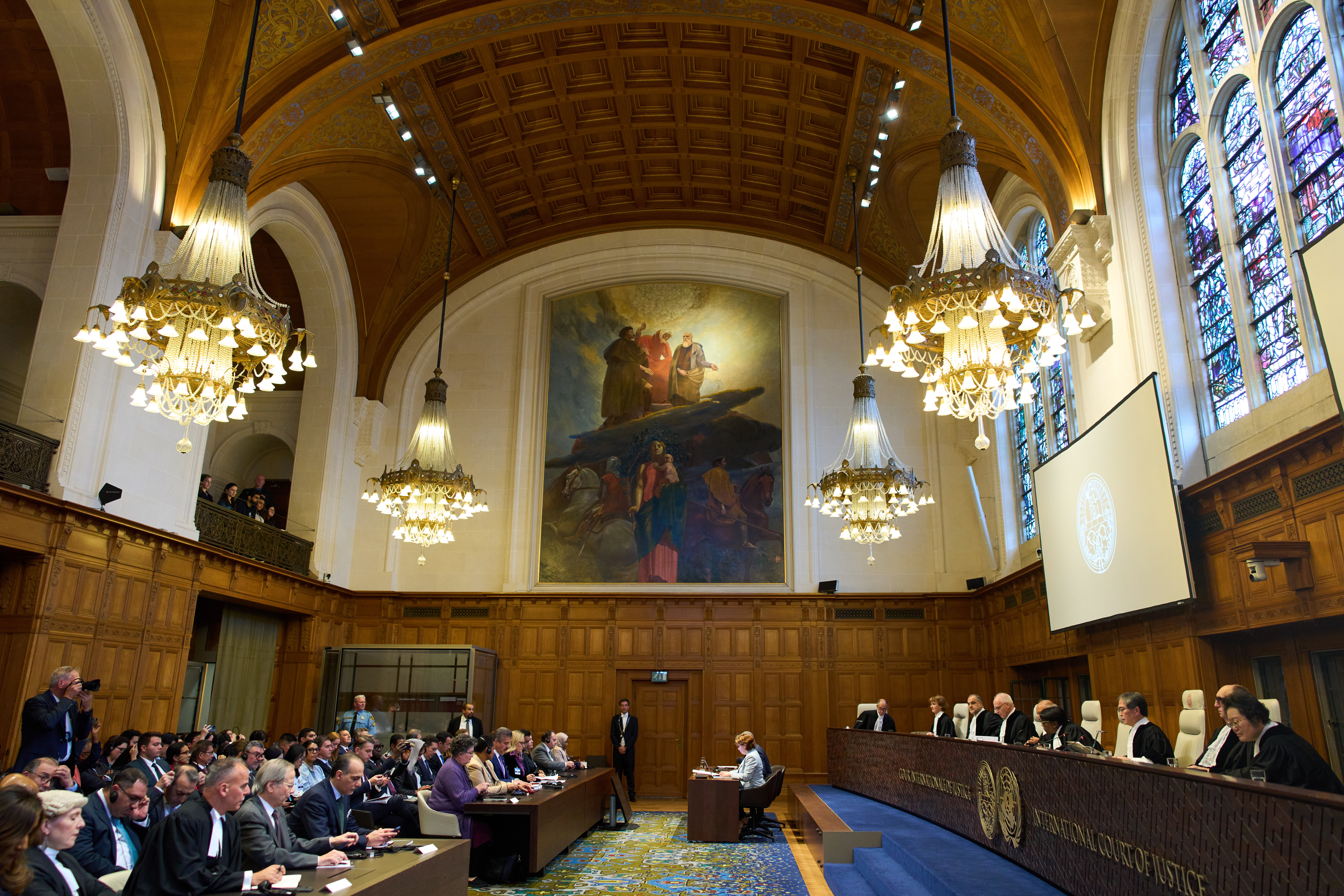 Presiding Judge Yuji Iwasawa, third from right, starts reading the advisory opinion of the International Court of Justice on what Israel must do to ensure humanitarian aid reaches Palestinians in Gaza and the occupied West Bank, in The Hague, Netherlands, Wednesday, Oct. 22, 2025. (AP Photo/Peter Dejong)