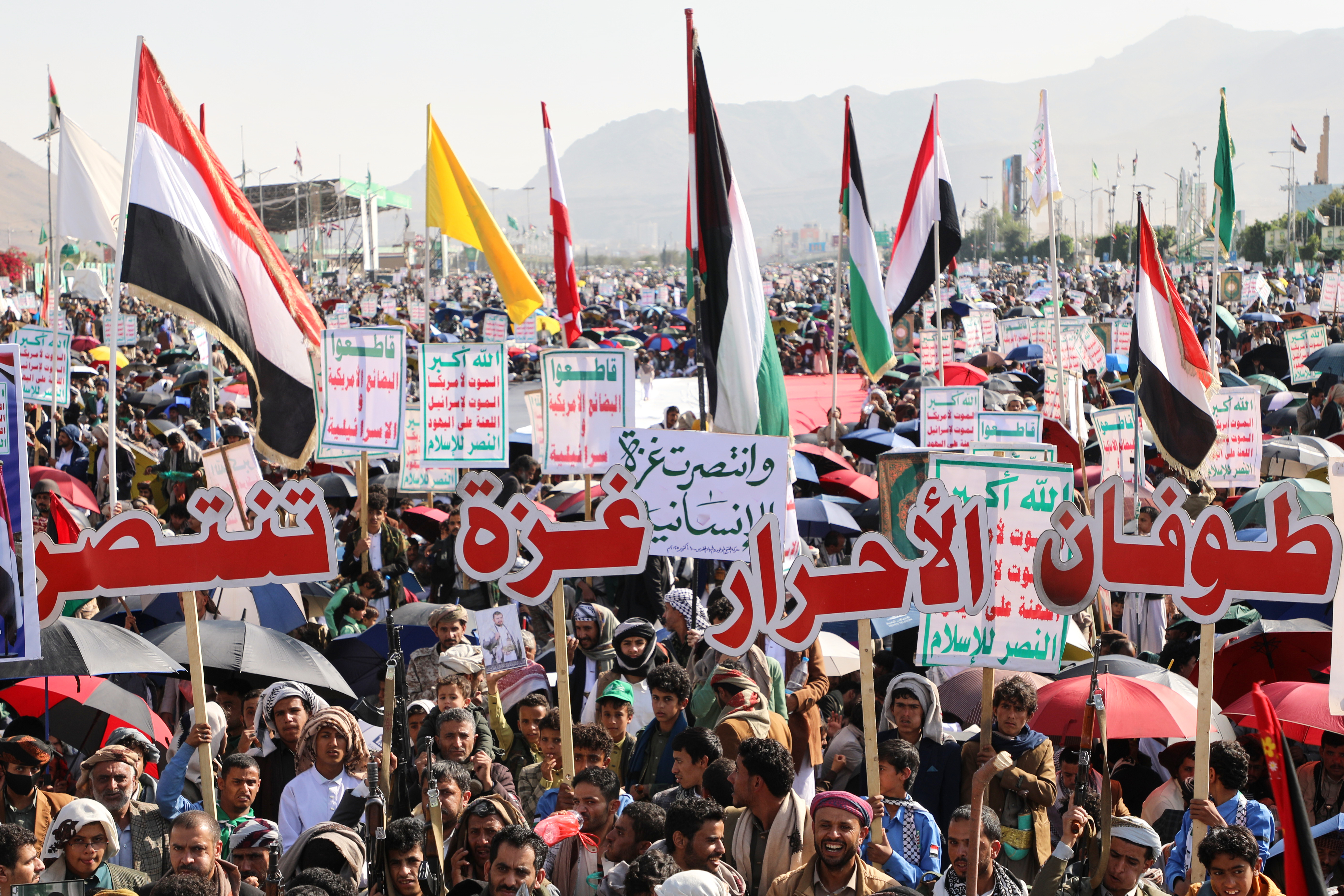 Houthi supporters celebrate following the announcement that Israel and Hamas have agreed to the first phase of a peace plan to pause the fighting, in Sanaa, Yemen, Friday, Oct. 10, 2025. Arabic reads, "Gaza victory". (AP Photo/Osamah Abdulrahman)