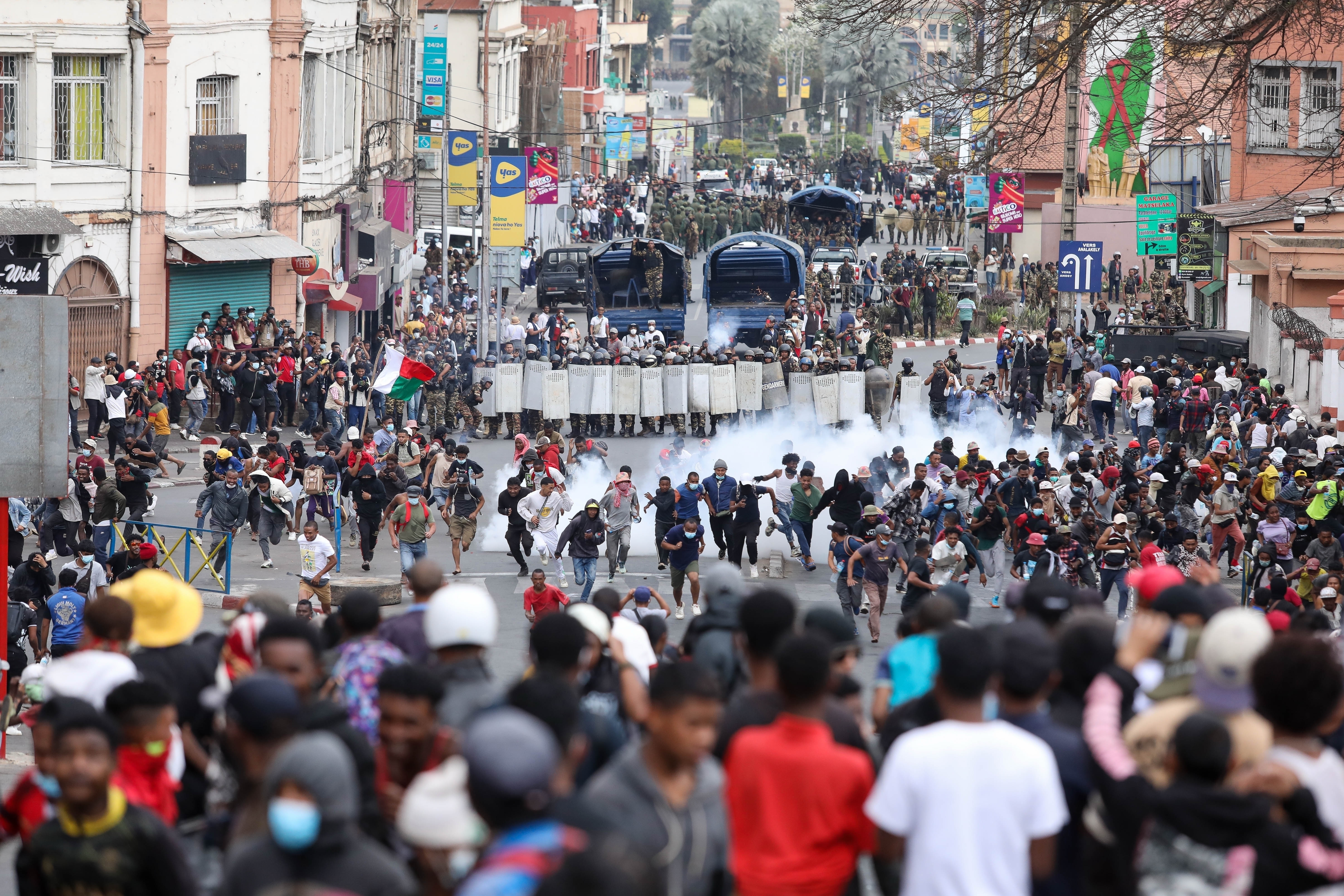 FILE - Demonstrators protesting against chronic electricity and water cuts confront riot police in Antananarivo, Madagascar, Tuesday, Sept. 30, 2025. (AP Photo/Mamyrael, File)