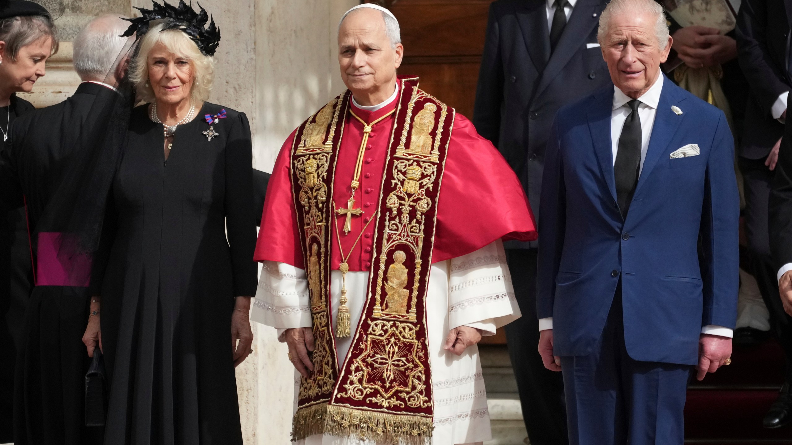 Pope Leo XIV, center, poses flanked by Britain's King Charles III and Queen Camilla in the St. Damasus Courtyard at the Vatican after a state visit and pray with him in the Sistine Chapel, Thursday, Oct. 23, 2025. (AP Photo/Andrew Medichini)
