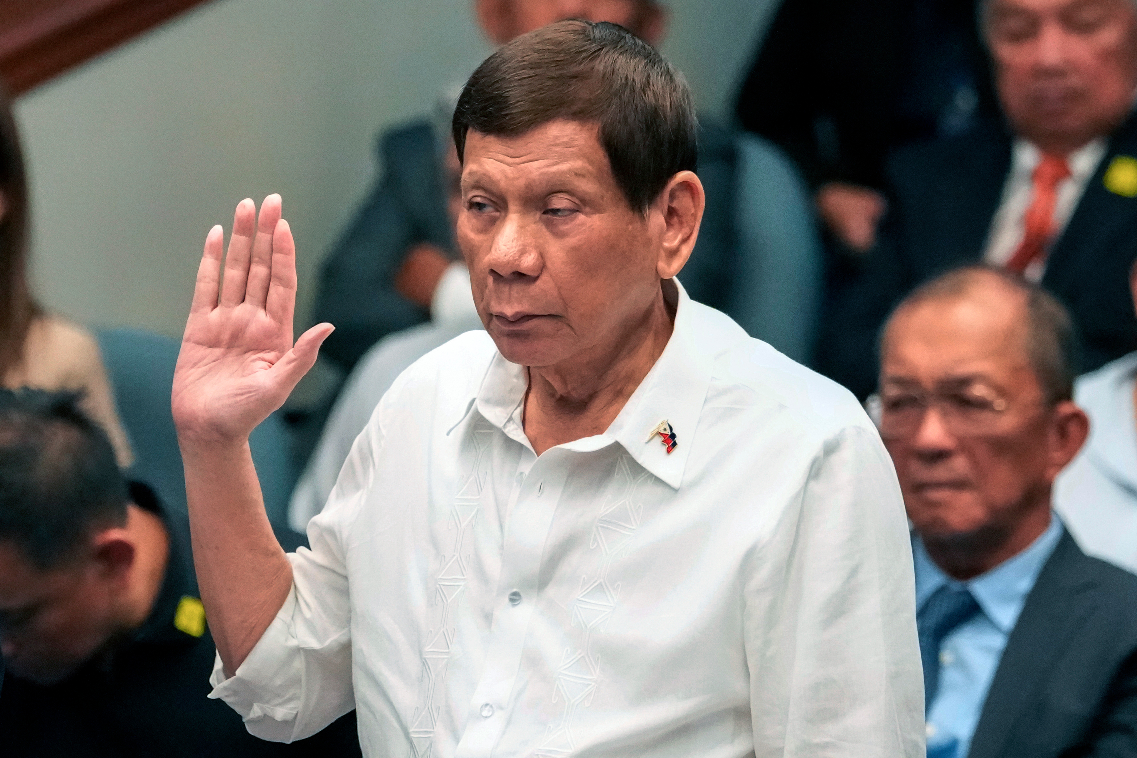 FILE - Former Philippine President Rodrigo Duterte takes oath during a senate inquiry on the so-called war on drugs during his administration at the Philippine Senate, on Oct. 28, 2024, in Manila, Philippines. (AP Photo/Aaron Favila, File)