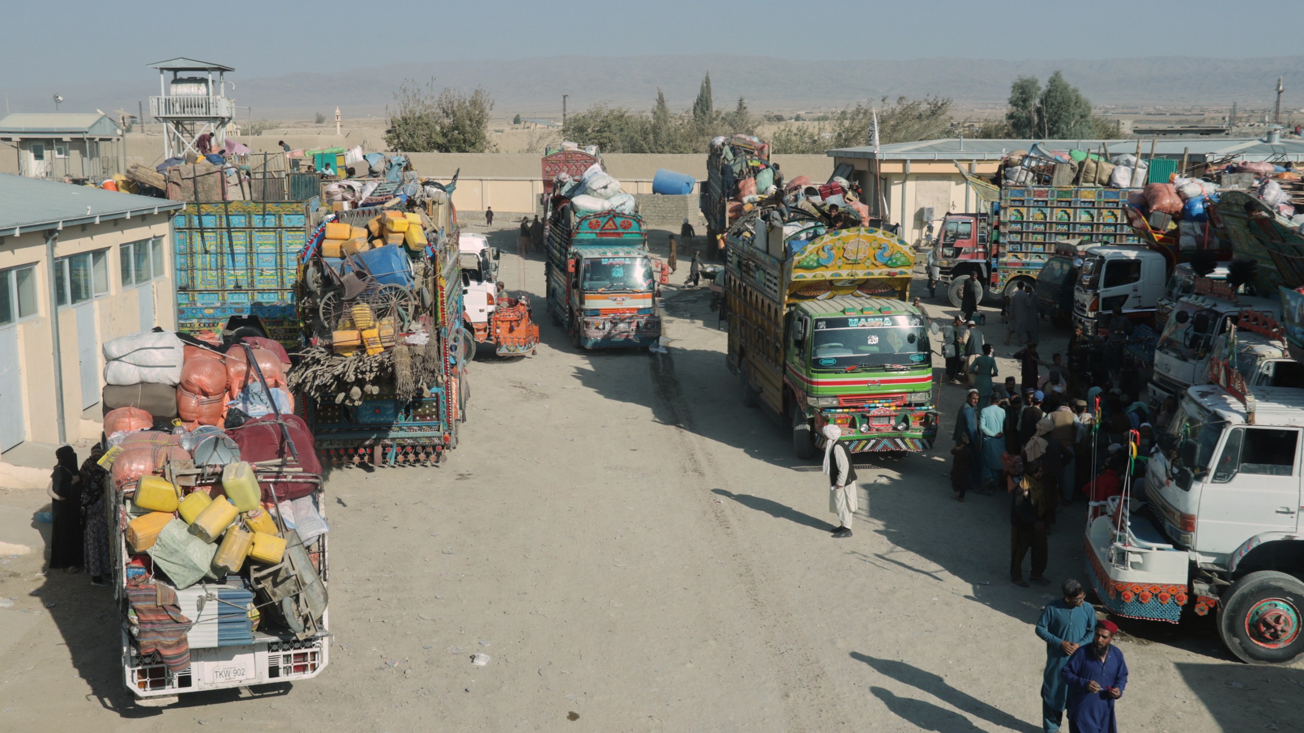 Trucks loaded with goods are parked near the closed Spin Boldak border crossing with Pakistan, after the border was shut for nearly two weeks following clashes between Afghan and Pakistani forces, in Kandahar province, Afghanistan, Thursday, Oct. 23, 2025. (AP Photo/Sibghatullah)