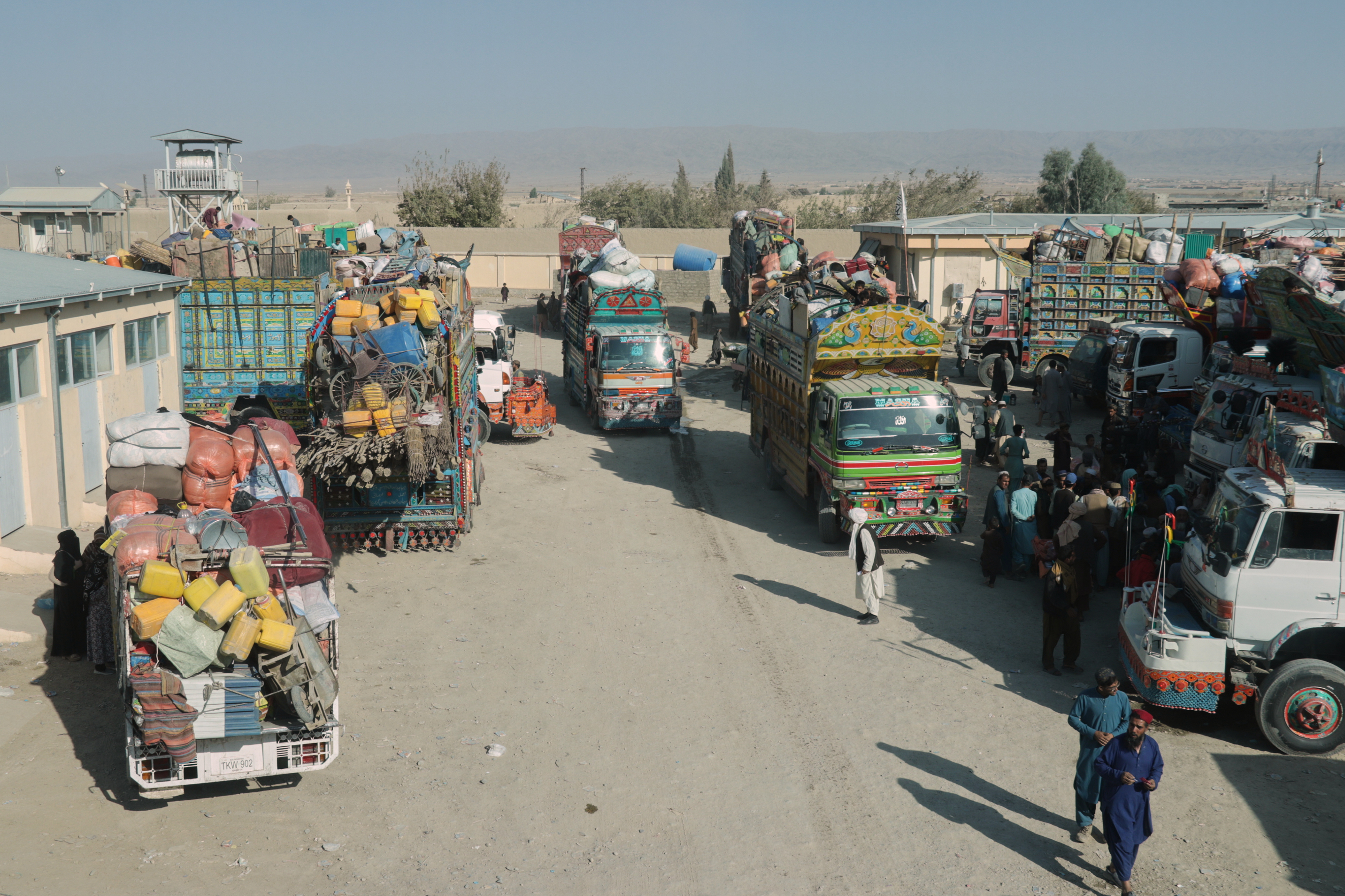 Trucks loaded with goods are parked near the closed Spin Boldak border crossing with Pakistan, after the border was shut for nearly two weeks following clashes between Afghan and Pakistani forces, in Kandahar province, Afghanistan, Thursday, Oct. 23, 2025. (AP Photo/Sibghatullah)