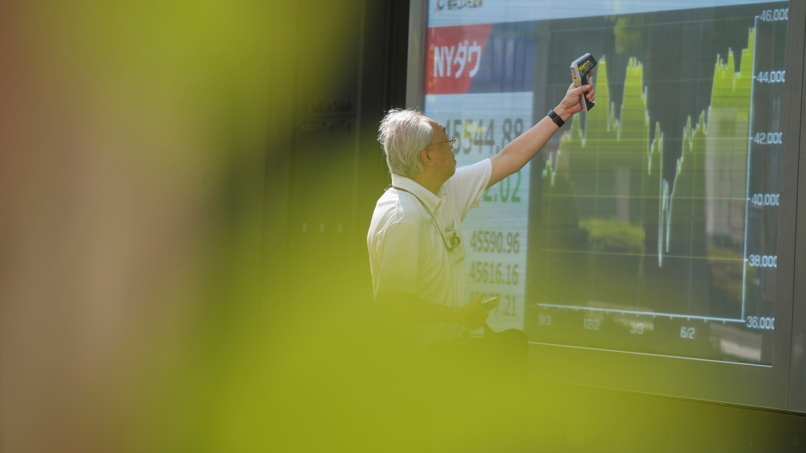 FILE -A staff check an electronic stock board prior to the opening of the stock market of the day at a securities firm Sept. 1, 2025, in Tokyo. (AP Photo/Eugene Hoshiko), File)