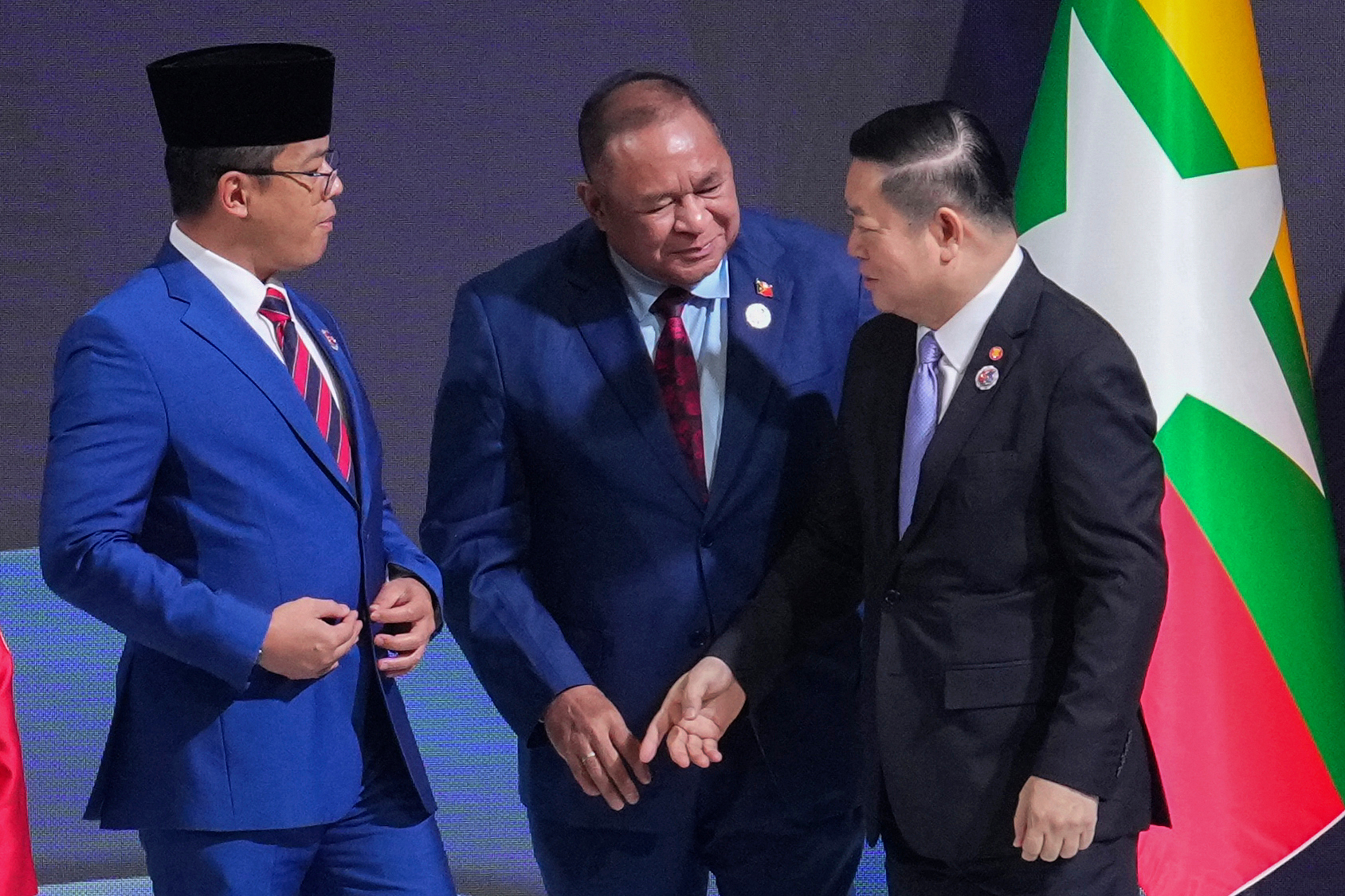 Indonesia's Foreign Minister Sugiono, left, and East Timor's Foreign Minister Bendito dos Santos Freitas, center, speak with ASEAN Secretary-General Kao Kim Hourn during the ASEAN foreign ministers/ meeting in Kuala Lumpur, Malaysia, Saturday, Oct. 25, 2025. (AP Photo/Rafiq Maqbool)