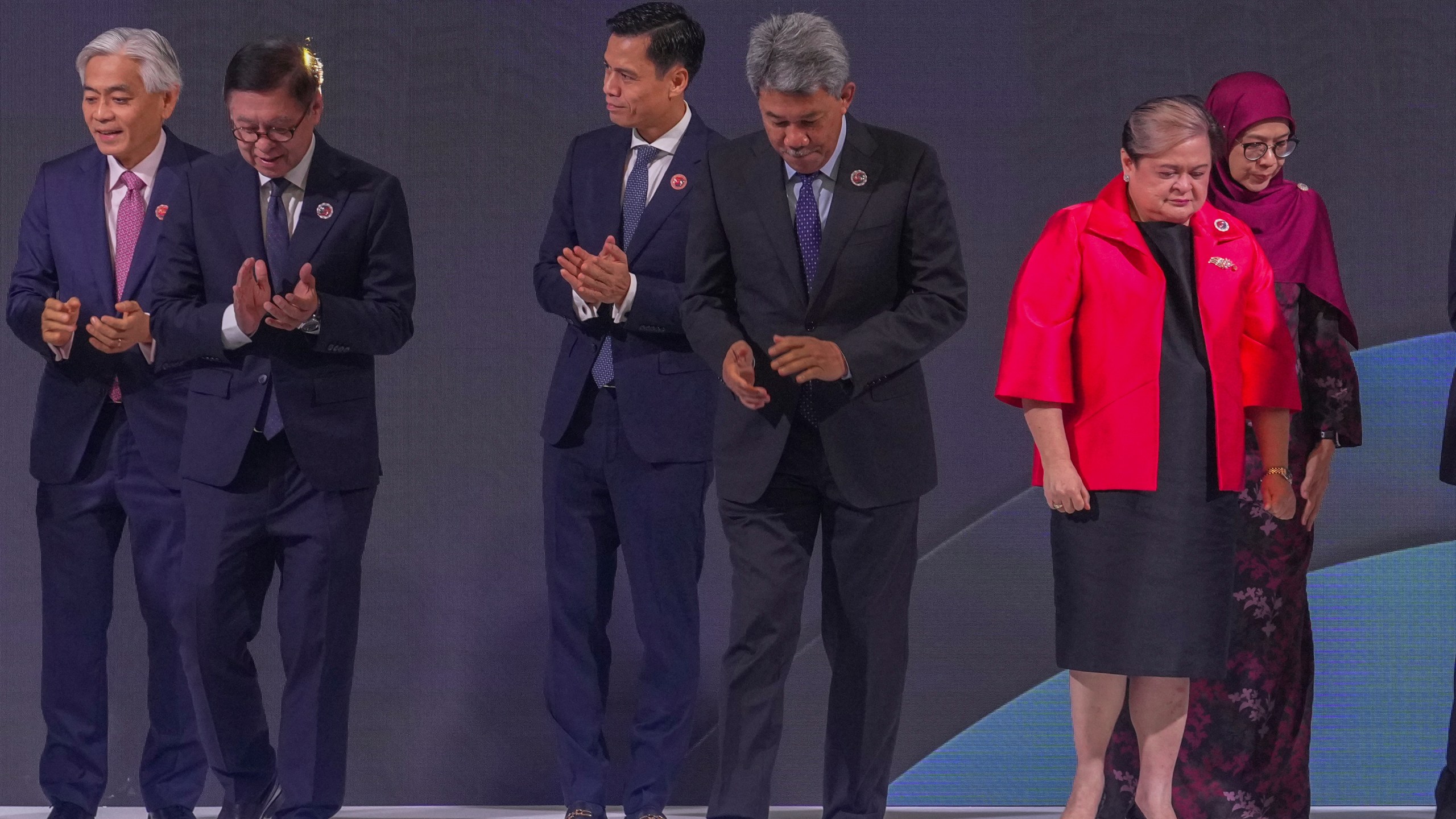 From left, Singapore's Permanent Secretary of Foreign Affairs Albert Chu, Thailand's Foreign Minister Sihasak Phuangketkeow, Vietnam's Deputy Minister of Foreign Affairs Dang Hoang Giang, Malaysia's Foreign Minister Mohamad Hasan, Philippine Foreign Secretary Theresa Lazaro and unidentified Brunei's representative leave after a group photo during ASEAN foreign ministers' meeting at the Kuala Lumpur Convention Centre in Kuala Lumpur, Malaysia, Saturday, Oct. 25, 2025. (AP Photo/Rafiq Maqbool)