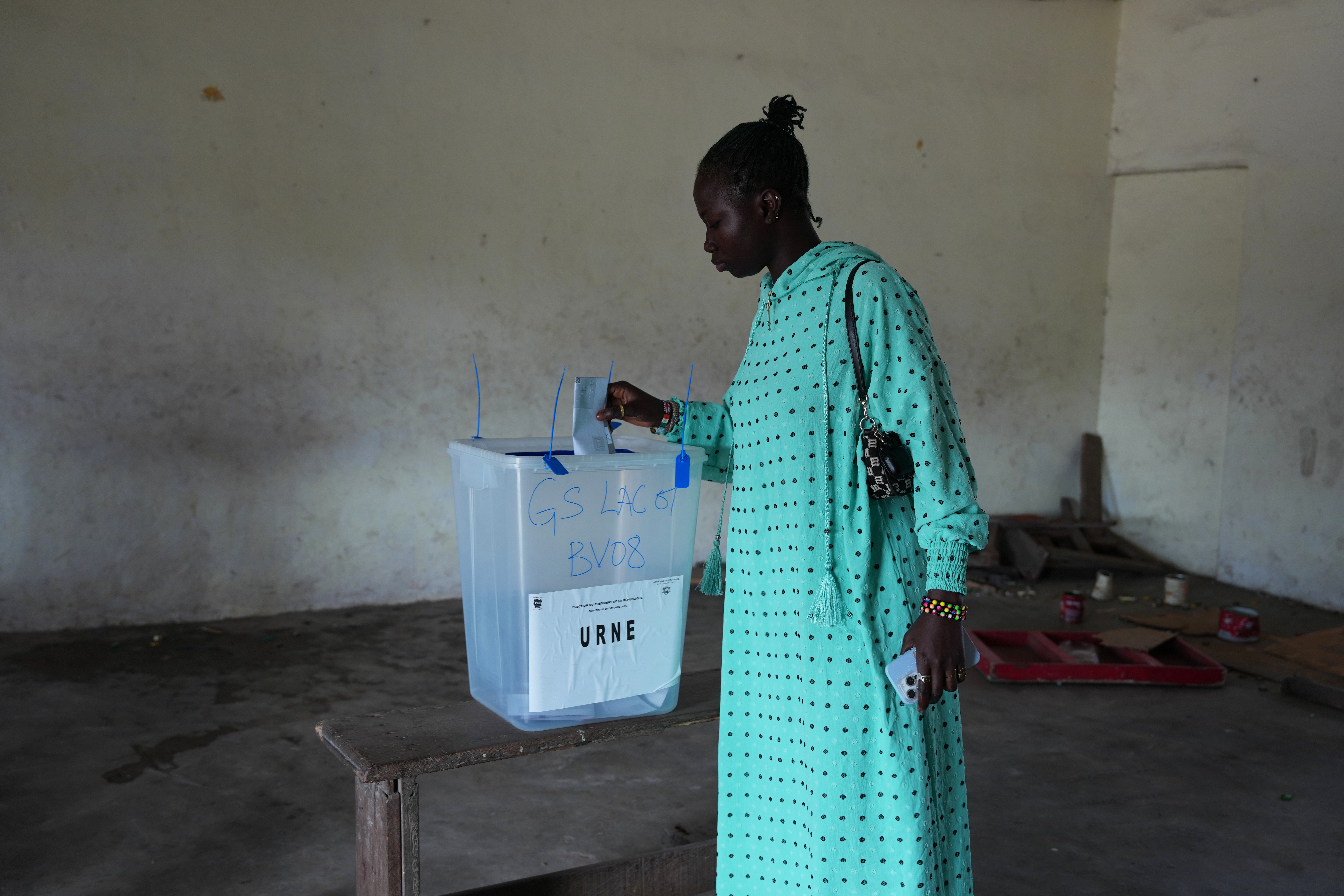 A woman casts her vote at a polling station during the presidential elections in Abidjan, Ivory Coast, Saturday, Oct. 25, 2025. (AP Photo/Misper Apawu)