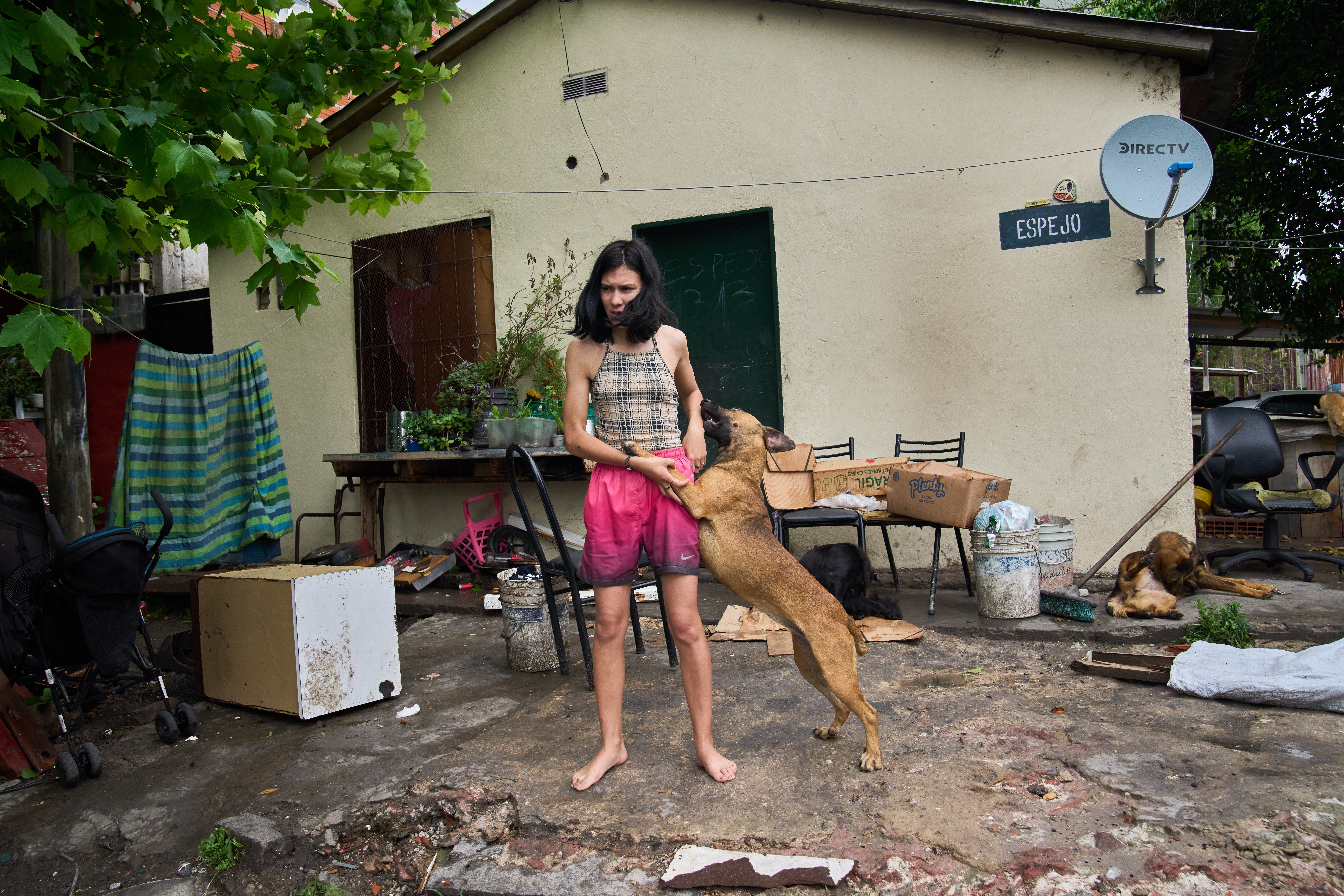 Abigail Rodriguez stands outside her home in the Isla Maciel neighborhood of Buenos Aires, Argentina, Friday, Oct. 24, 2025. (AP Photo/Rodrigo Abd)