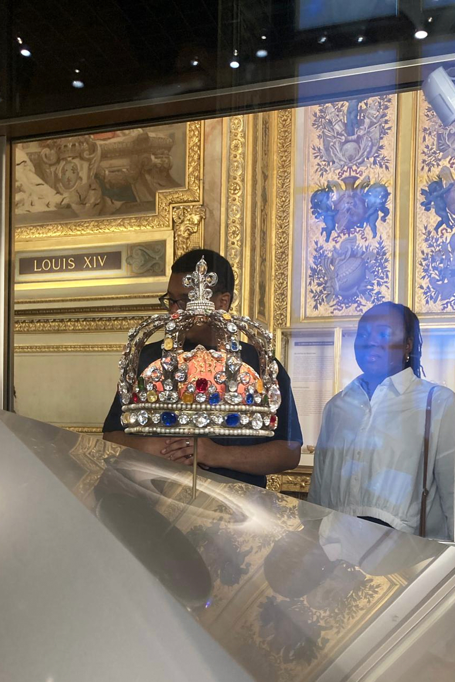 People check jewelry in the Apollo Gallery of the Louvre museum on Sept. 4, 2025 in Paris. (AP Photo/Alexander Turnbull)