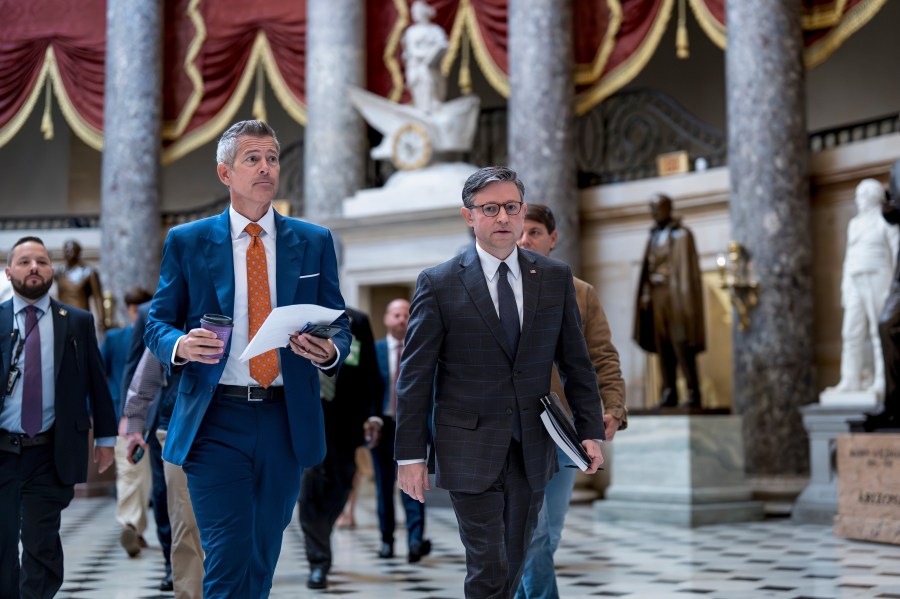 Transportation Secretary Sean Duffy, left, and Speaker of the House Mike Johnson, R-La., walk through Statuary Hall at the Capitol to a news conference on day 23 of the government shutdown, in Washington, Thursday, Oct. 23, 2025. (AP Photo/J. Scott Applewhite)