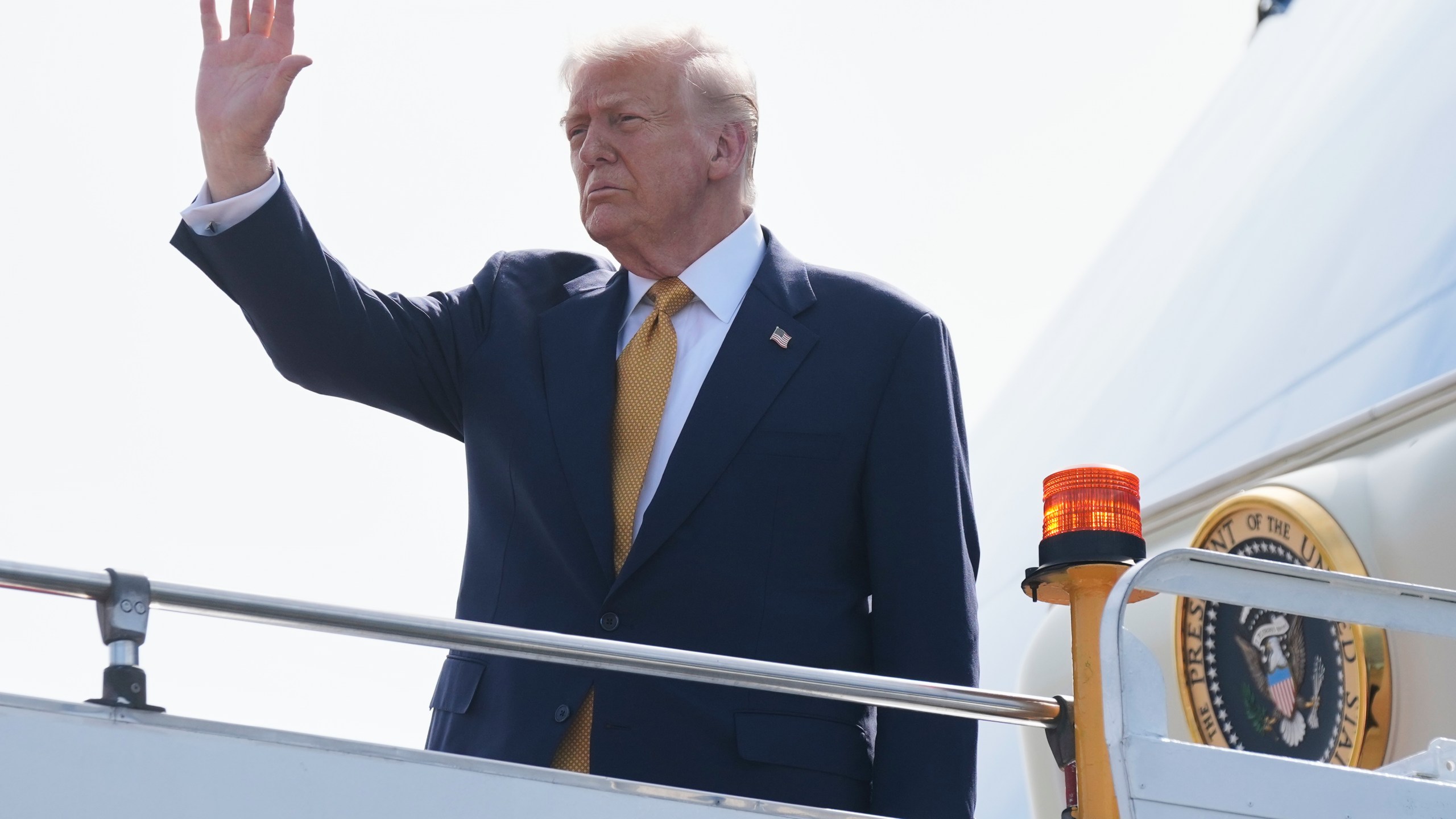 President Donald Trump waves as he boards Air Force One at Kuala Lumpur International Airport in Sepang, Malaysia, as he departs for Japan, Monday, Oct. 27, 2025. (AP Photo/Mark Schiefelbein)