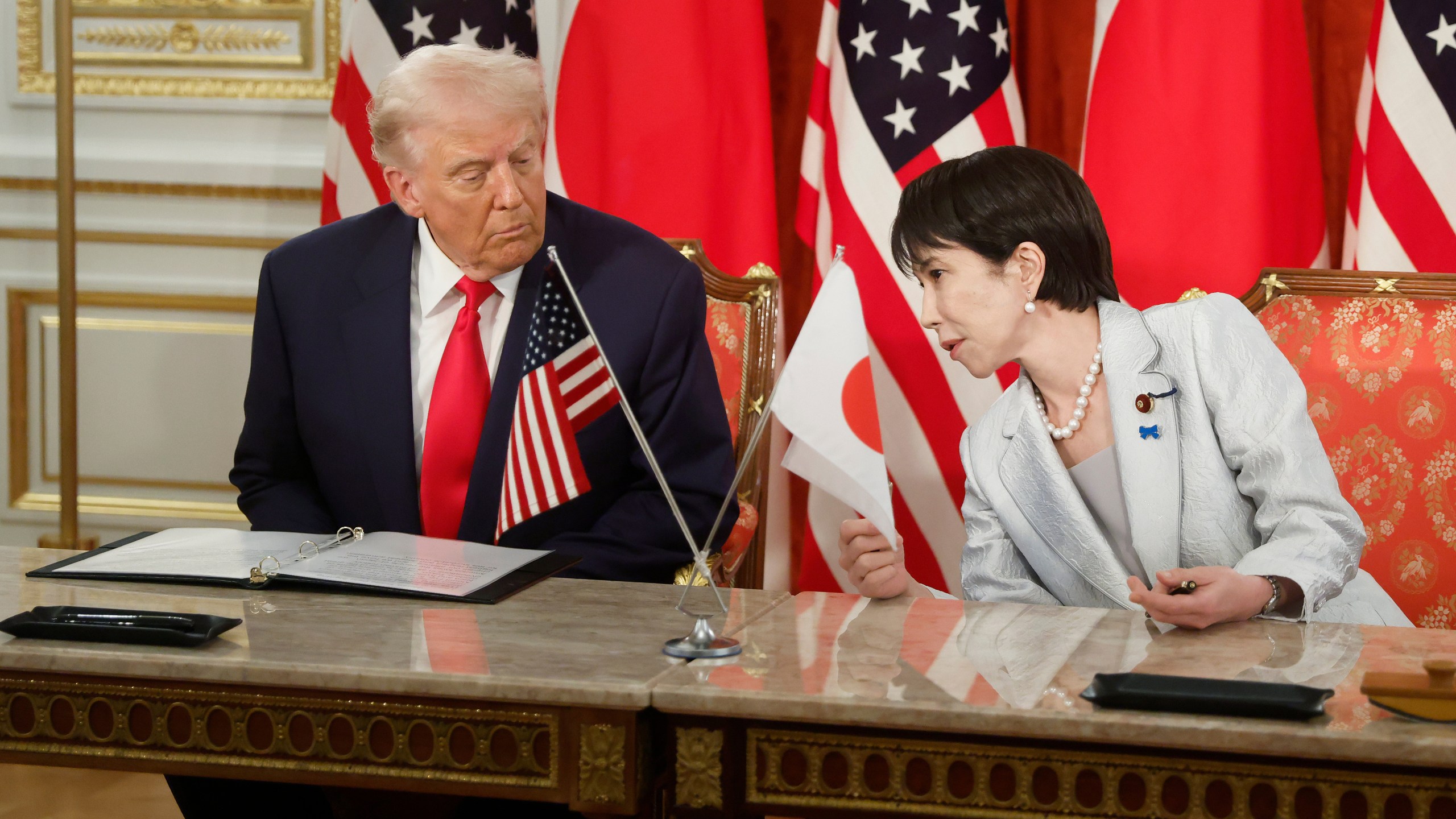 U.S. President Donald Trump, left, and Japan's Prime Minister Sanae Takaichi attend a signing ceremony at Akasaka Palace state guest house in Tokyo Tuesday, Oct. 28, 2025. (Kiyoshi Ota/Pool Photo via AP)