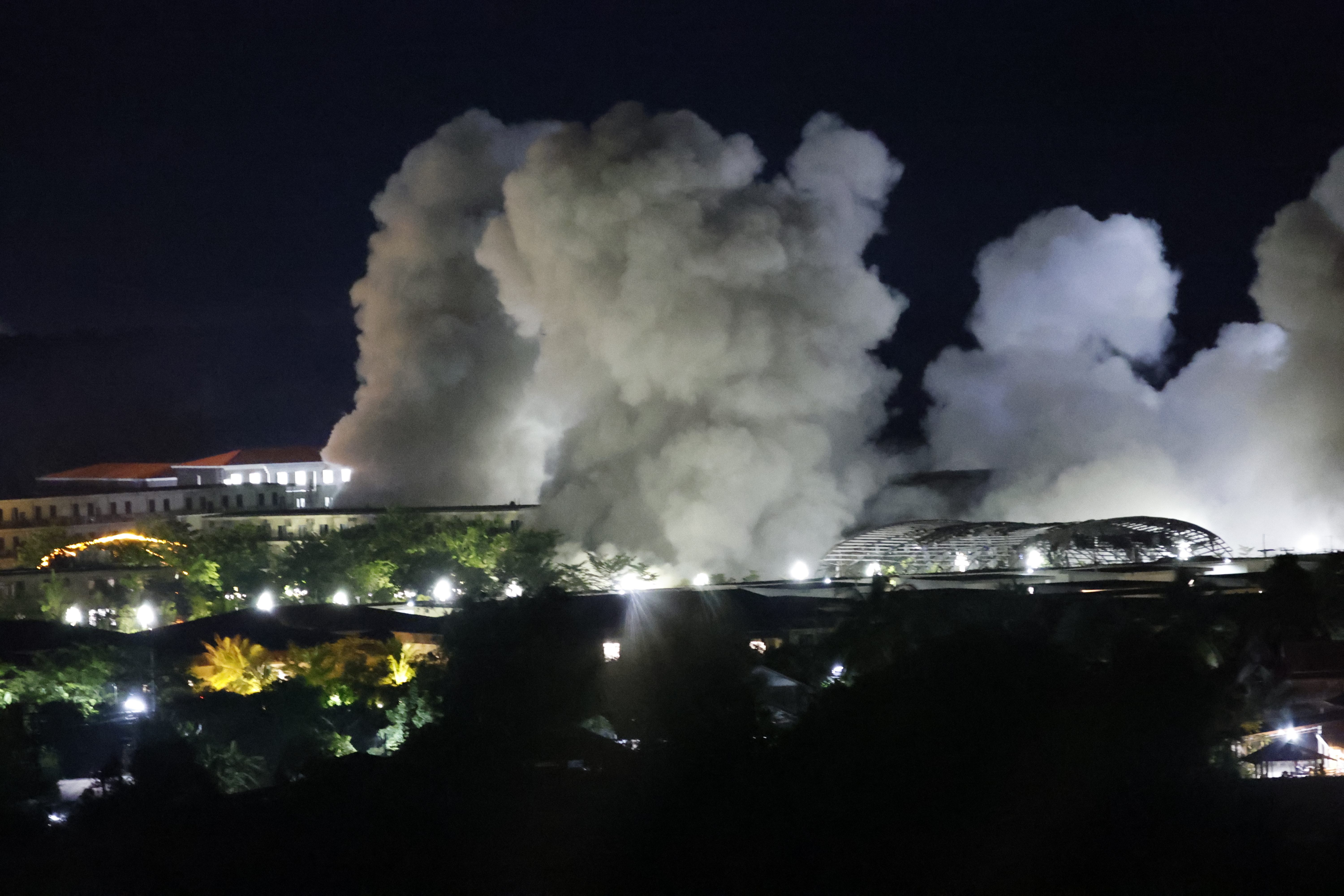 White smoke billows after an explosion at KK Park online scam center in Myawaddy township, Karen State, Myanmar, Saturday, Oct. 25, 2025. (AP Photo/Sarot Meksophawannakul)