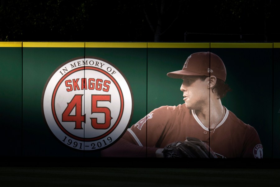 FILE - An image and logo memorializing former Los Angeles Angels pitcher Tyler Skaggs is displayed on the outfield wall in Anaheim, Calif., July 17, 2019. (AP Photo/Kyusung Gong, File)