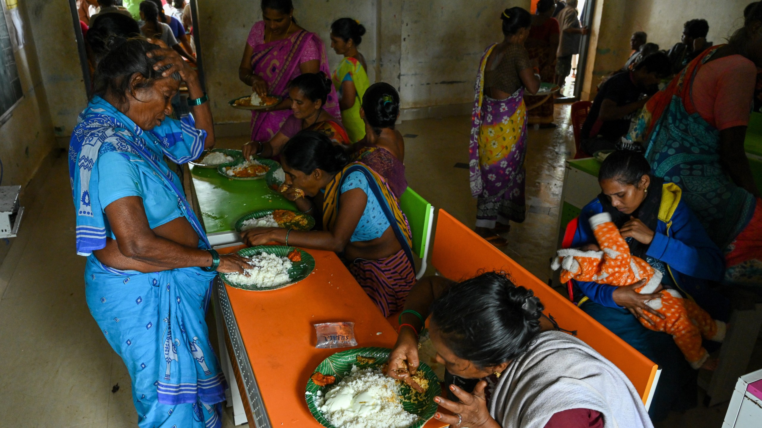 Evacuated Indian villagers of Uppada eat food in a temporary relief centre as Cyclone Montha, in Kakinada district of Andhra Pradesh, India, Tuesday, Oct. 28, 2025. (AP Photo)