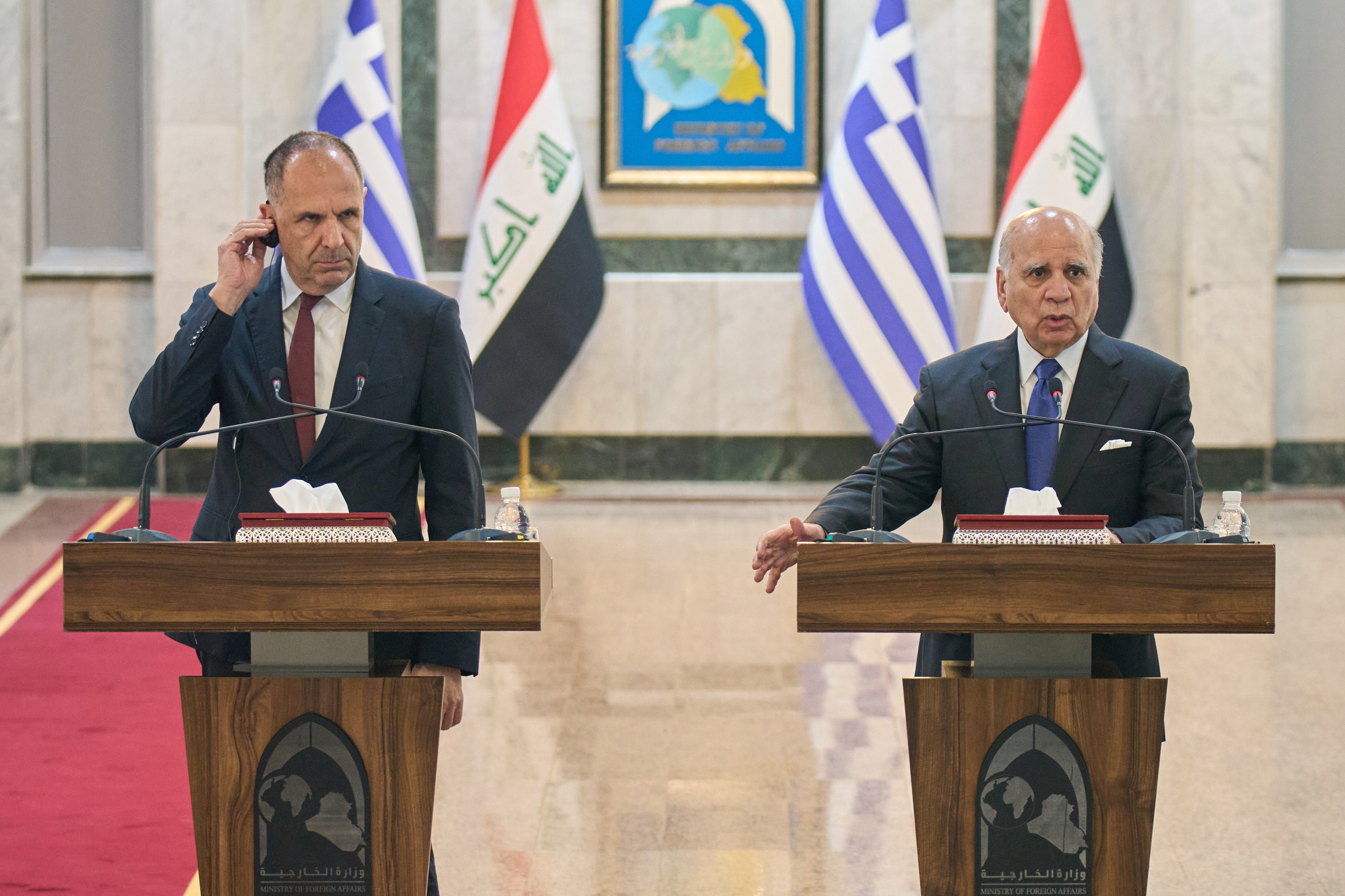 Greek Foreign Minister George Gerapetritis, left, listens to his Iraqi counterpart Fuad Hussein during a news conference after a meeting at the foreign ministry in Baghdad, Iraq, Thursday, Oct. 30, 2025. (AP Photo/Hadi Mizban)