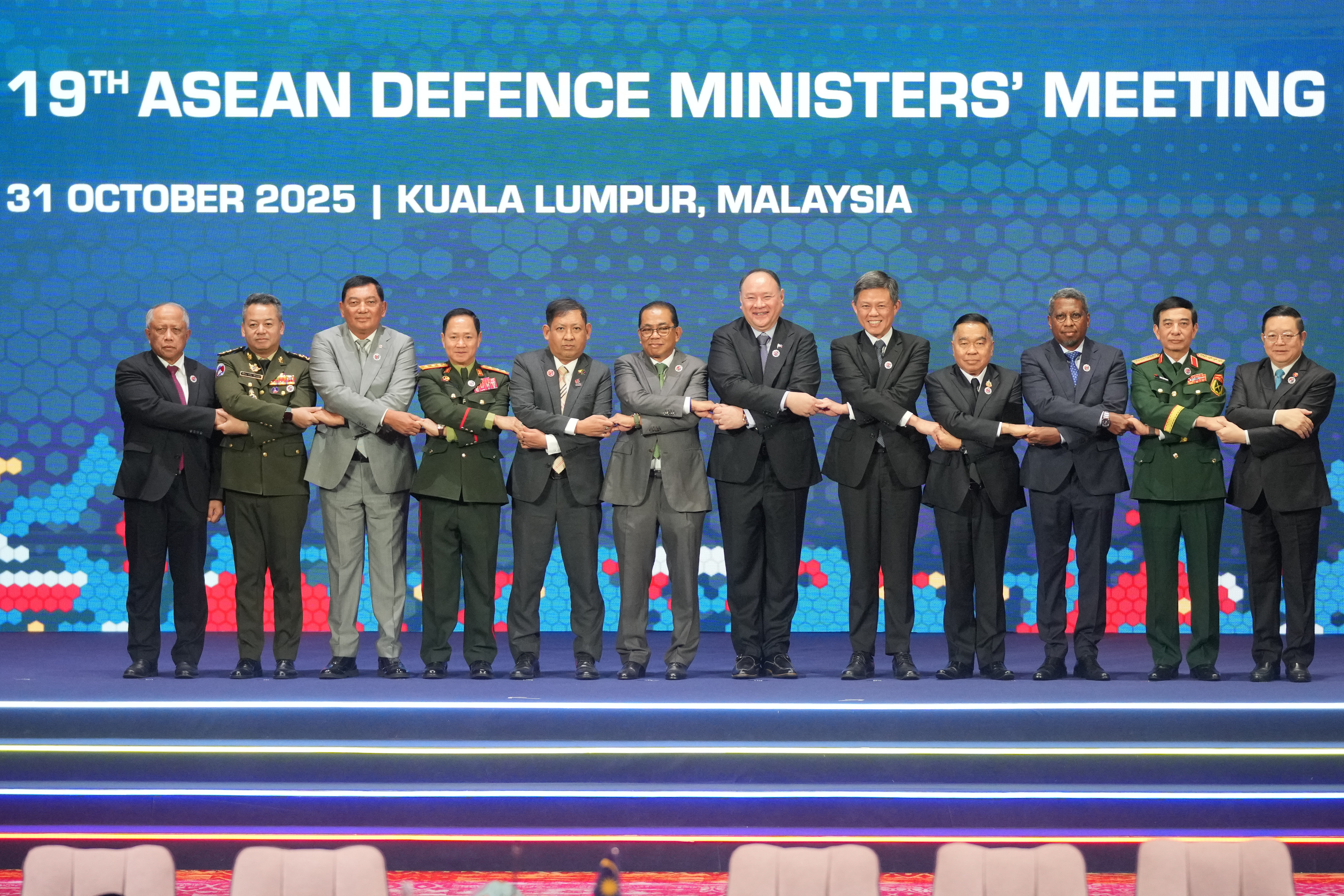 From left, Brunei's Defense Minister Halbi bin Haji Mohd Yussof, Cambodia's Defense Minister Tea Seiha, Indonesia's Defense Minister Sjafrie Sjamsoeddin, Laos' Defense Minister Khamlieng Outhakaisone, Myanmar's Permanent Secretary of the Ministry of Foreign Affairs Aung Kyaw Moe, Malaysia's Defense Minister Mohamed Khaled Nordin, Philippine's Defense Secretary Gilberto Teodoro, Singapore's Defense Minister Chan Chun Sing, Thailand's Defense Minister Natthaphon Narkphanit, East Timor's Defense Minister Donaciano da Costa Gomes, Vietnam's Defense Minister Phan Van Giang, and ASEAN Secretary-General Kao Kim Hourn hold hands as they pose for a group photo during the opening session of the Association of Southeast Asian Nations (ASEAN) Defense Ministers' Meeting in Kuala Lumpur, Malaysia, Friday, Oct. 31, 2025. (AP Photo/Dita Alangkara, Pool)