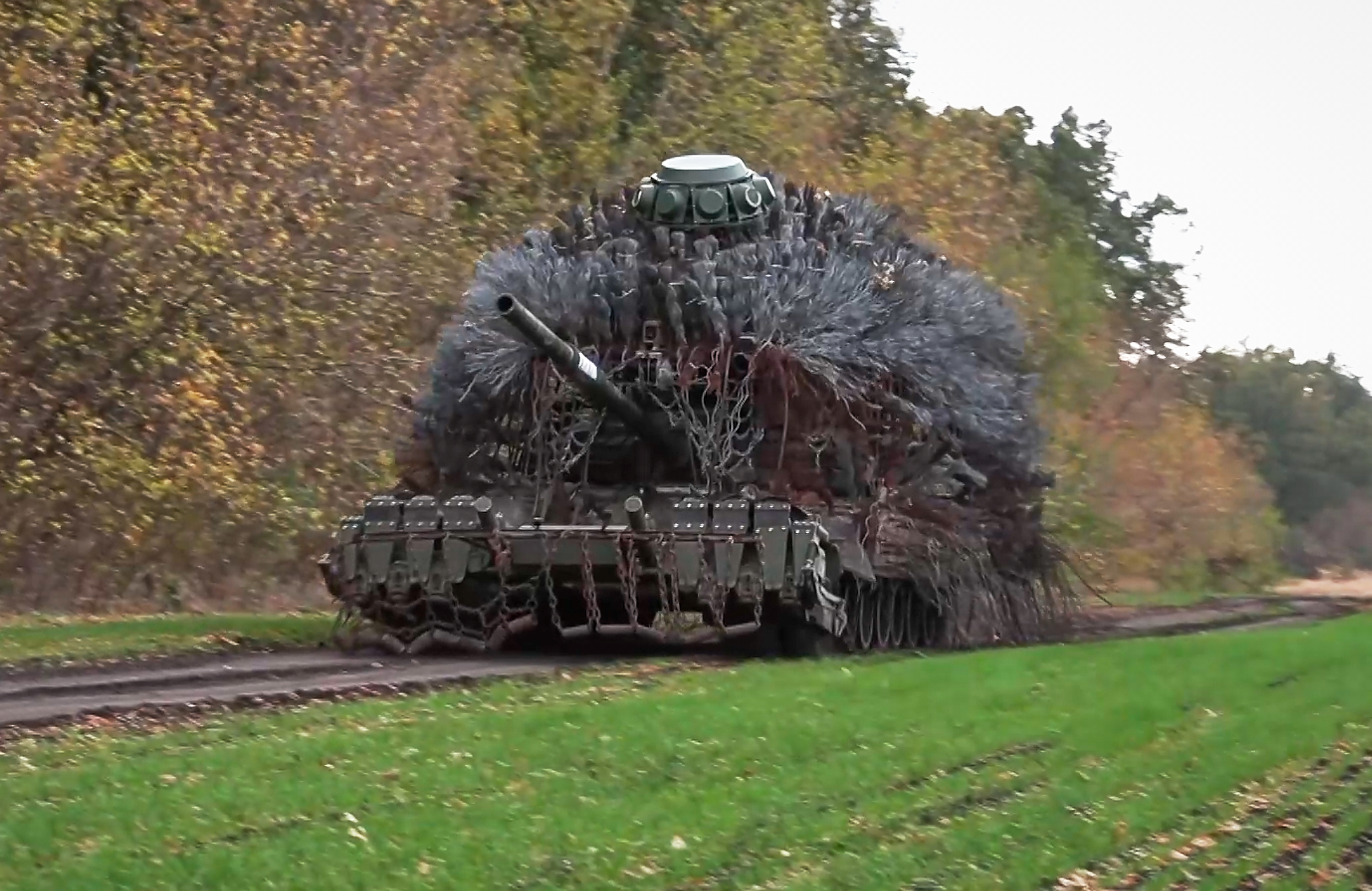 In this image made from video provided by Russian Defense Ministry Press Service on Friday, Oct. 31, 2025, a Russian tank rolls to fire towards Ukrainian positions on an undisclosed location in Ukraine. (Russian Defense Ministry Press Service via AP)